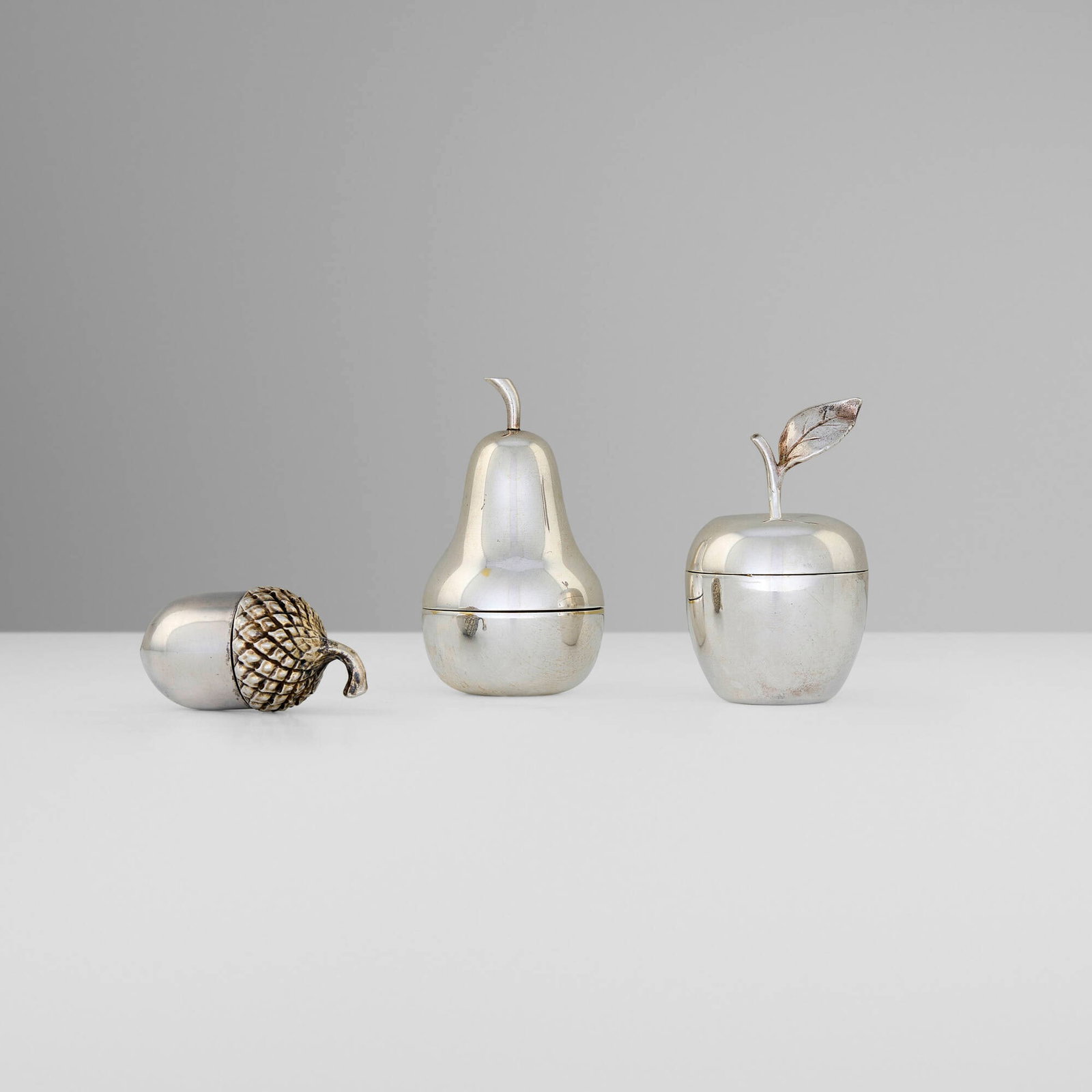 Tiffany & Co., Collection of three fruit and nut-form pill boxes: Tiffany & Co. Collection of three fruit and nut-form pill boxes New York, USA, second half of the 20th century sterling silver parcel-gilt 2.5 h x 1.5 dia in (6 x 4 cm) 2.25 h x 1 dia in (6 x 3 cm)