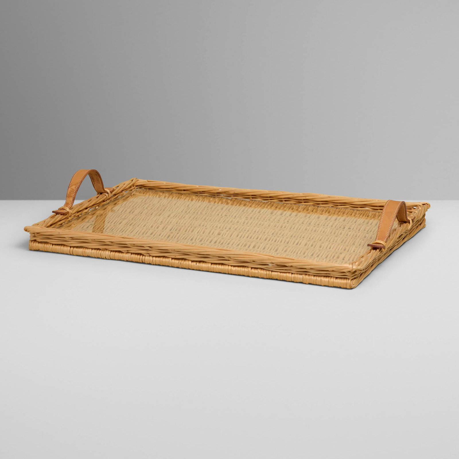 Hermes, Oseraie tray: Hermes Oseraie tray France, c. 2010 rattan, glass, leather 2 h x 21 w x 14.5 d in (5 x 53 x 37 cm) Embossed manufacturer's mark to handle 'Hermes'. This work will ship from