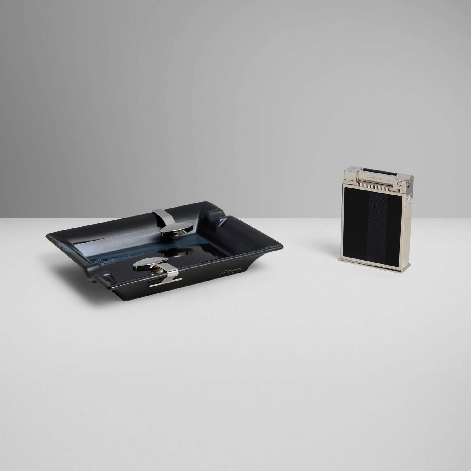 S.T. Dupont, James Bond 007 Casino Royale jeroboam table lighter and ashtray: S.T. Dupont James Bond 007 Casino Royale jeroboam table lighter and ashtray France, 2006 lacquer, chrome-plated metal, glazed porcelain 6.5 h x 7.75 w x 1.25 d in (17 x 20 x 3 cm) 4 h x 2.75 w x 1 d