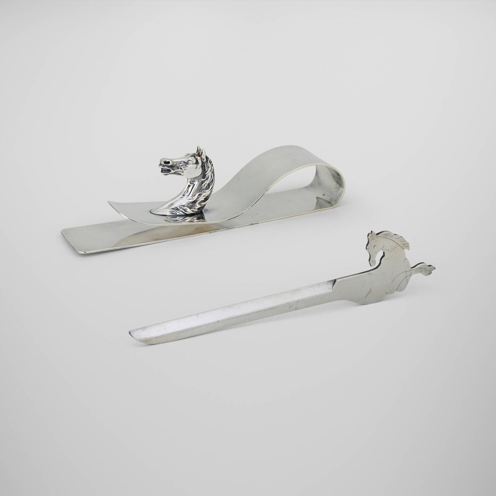 Hermes, Equestrian desk articles, set of two: Hermes Equestrian desk articles, set of two Ravinet d'Enfert & Cie France, c. 1965 silver-plated metal 2.5 h x 8.75 w x 2 d in (6 x 22 x 5 cm) 2 h x 8.75 w x 0.25 d in (5 x 22 x 1 cm) S