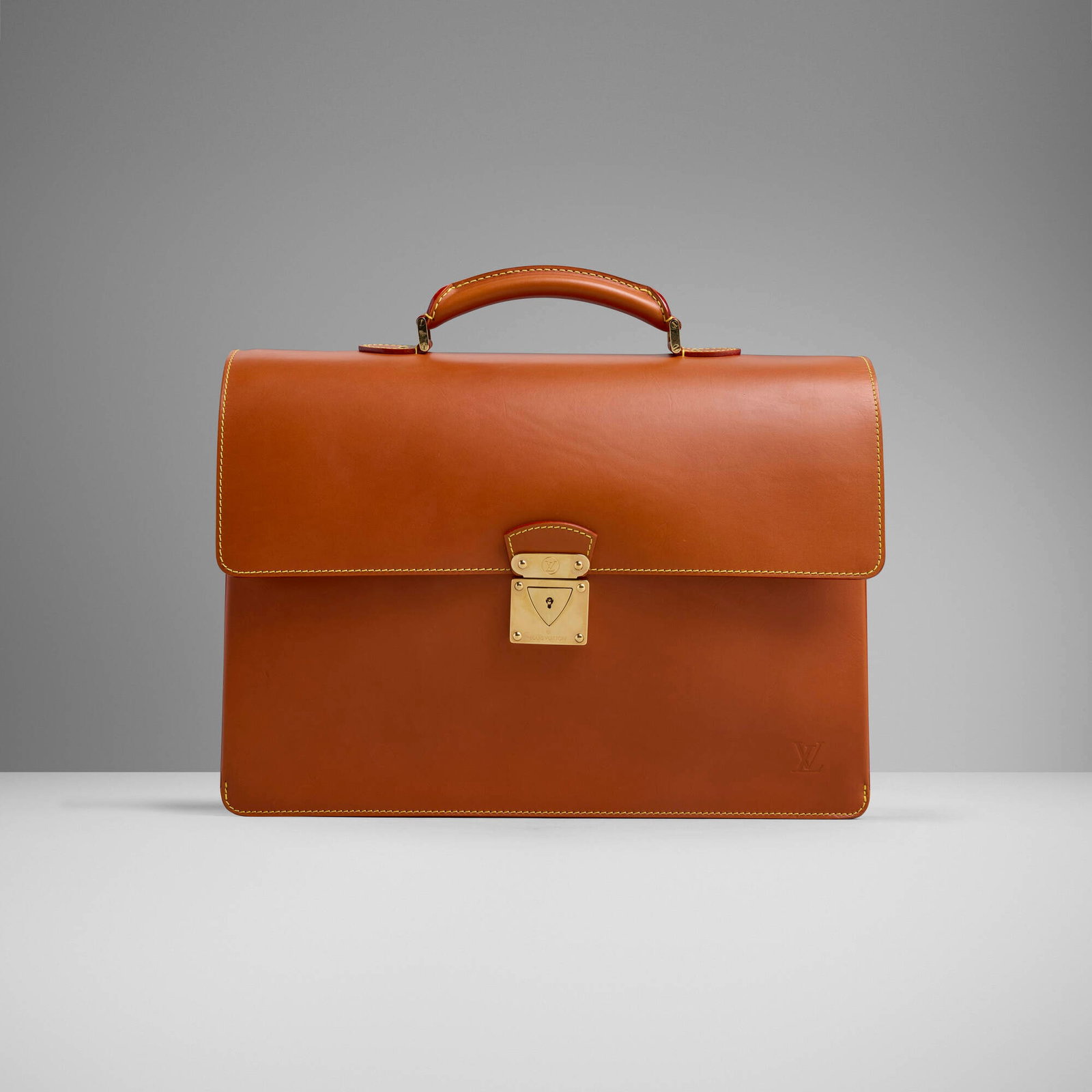 Louis Vuitton, Robusto II briefcase: Louis Vuitton Robusto II briefcase France, c. 2005 Nomad leather, gold-plated brass 13.5 h x 16 w x 4 d in (34 x 41 x 10 cm) Impressed manufacturer's logo to hardware and to front. Impressed