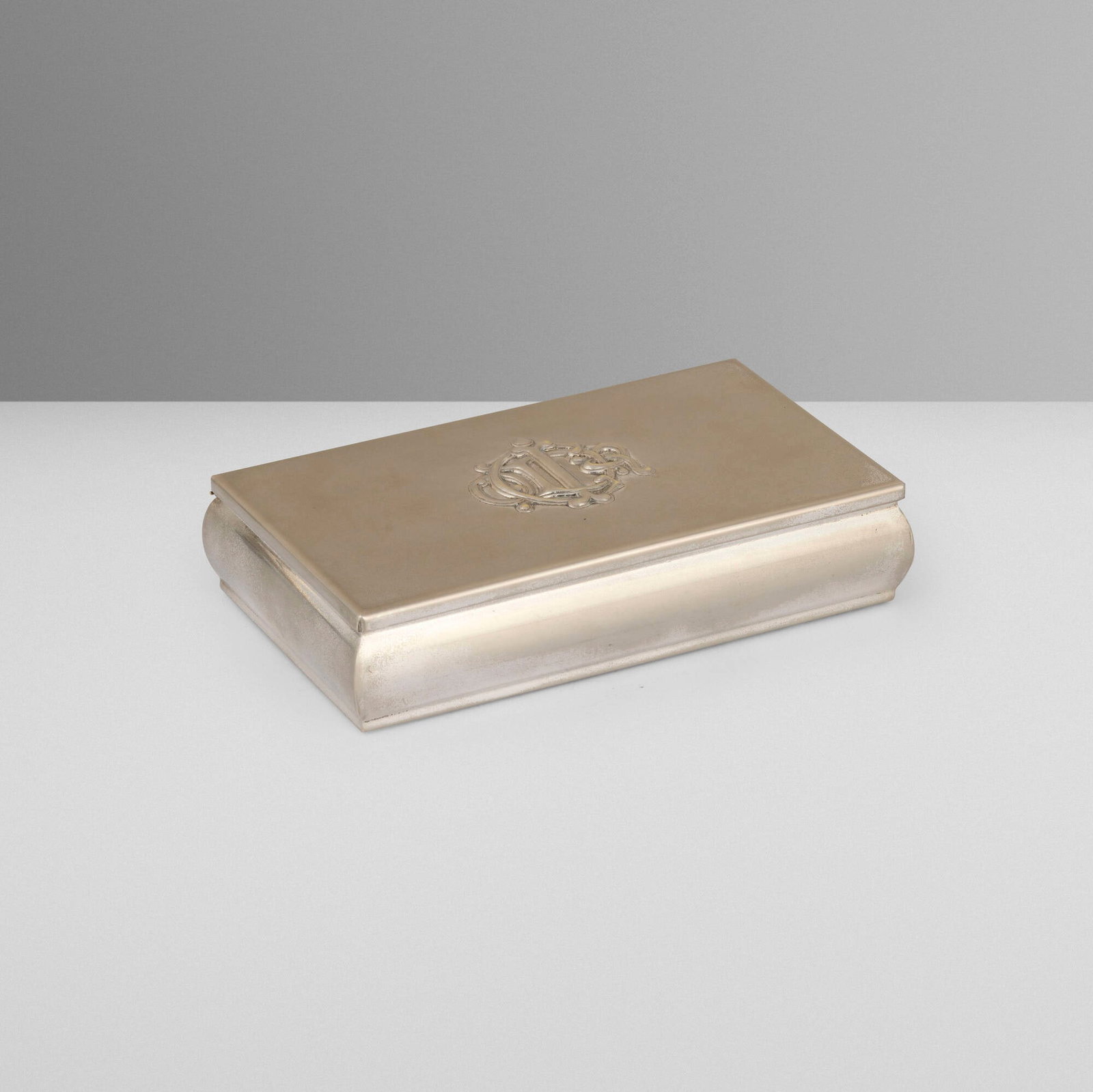 Christian Dior, Monogram cigarette box: Christian Dior Monogram cigarette box France/Italy / Greece, c. 1985 silver-plated metal, felt 1.875 h x 7.75 w x 4.625 d in (5 x 20 x 12 cm) Box features entwined brand monogram to top 'C