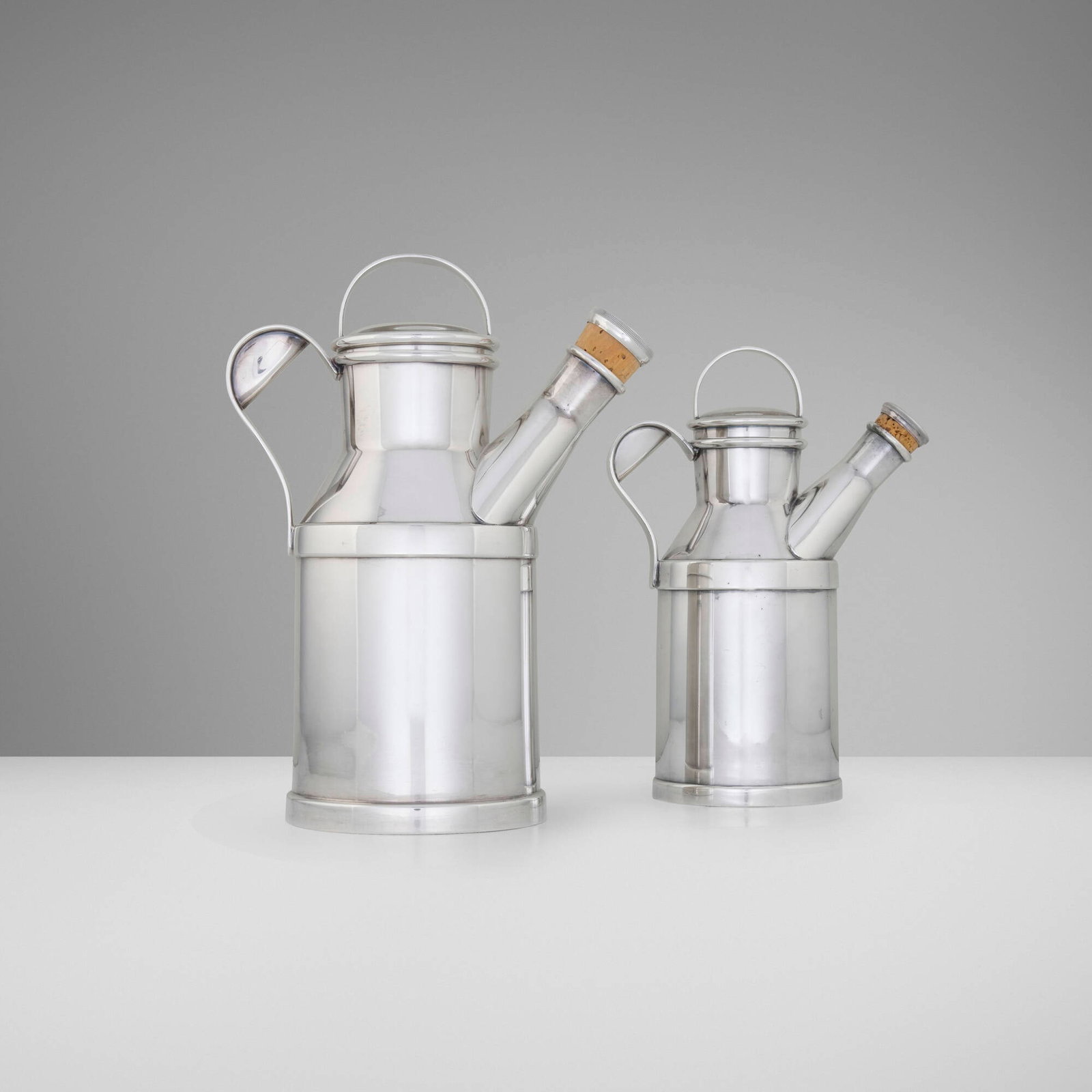Reed & Barton, Milk Jug cocktail shakers, set of two: Reed & Barton Milk Jug cocktail shakers, set of two Taunton, USA, 1938 silver-plated metal, cork 11 h x 8 w x 5 d in (28 x 20 x 13 cm) 9.5 h x 7 w x 4 d in (24 x 18 x 10 cm) Impressed