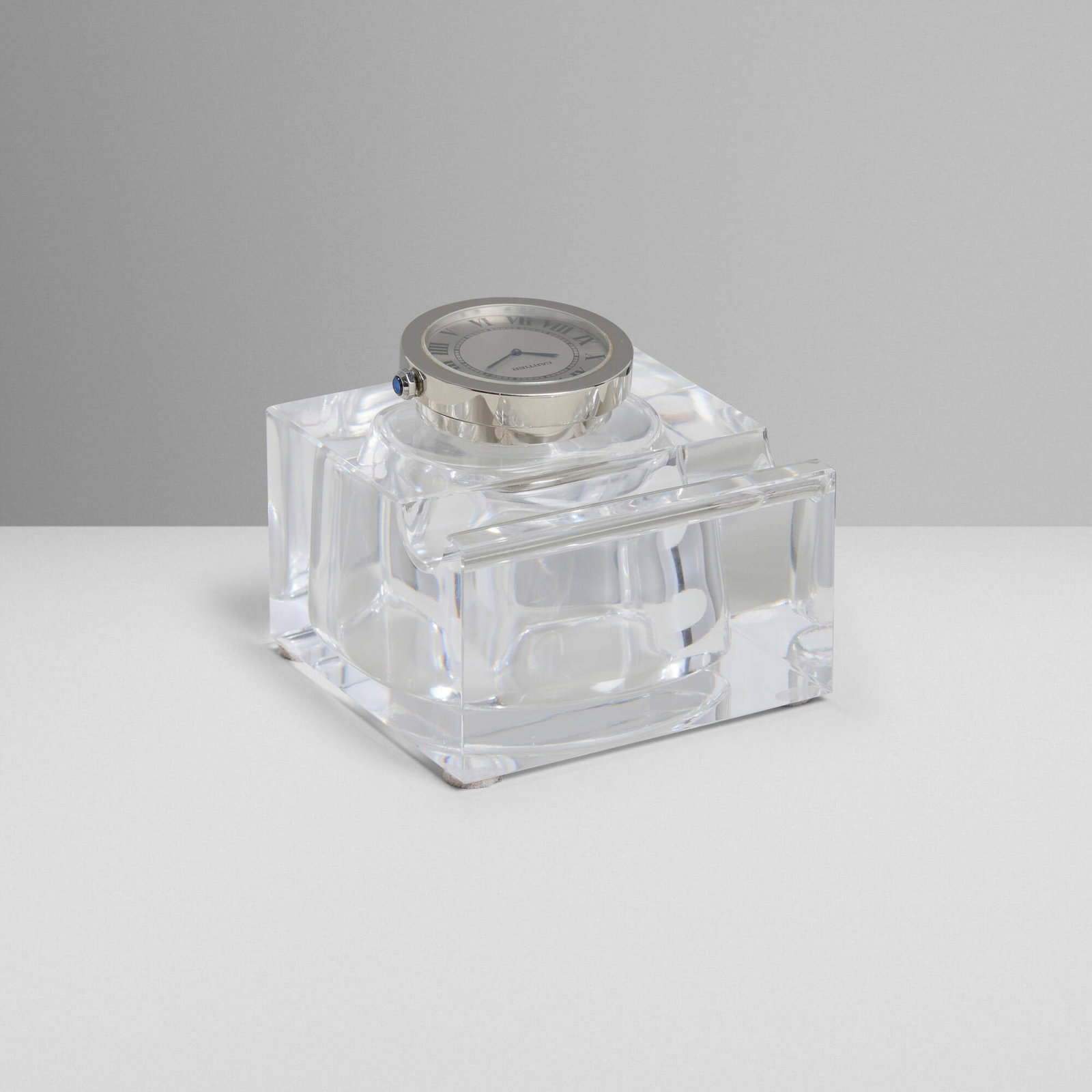 Cartier, Desk inkwell with clock and pen holder: Cartier Desk inkwell with clock and pen holder France, 21st century crystal, stainless steel 2.75 h x 3 w x 3 d in (7 x 8 x 8 cm) Etched manufacturer's mark to face and reverse 'Cartier N