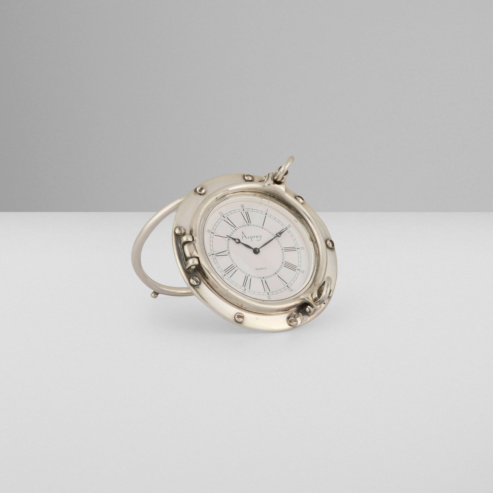 Asprey & Co., Porthole travel clock: Asprey & Co. Porthole travel clock United Kingdom / Arezzo, Italy, c. 1960 sterling silver, enameled brass, glass open: 2.25 h x 2.25 w x 3.125 d in (6 x 6 x 8 cm) closed: 2.375 h x 2.25 w x 0.875 d