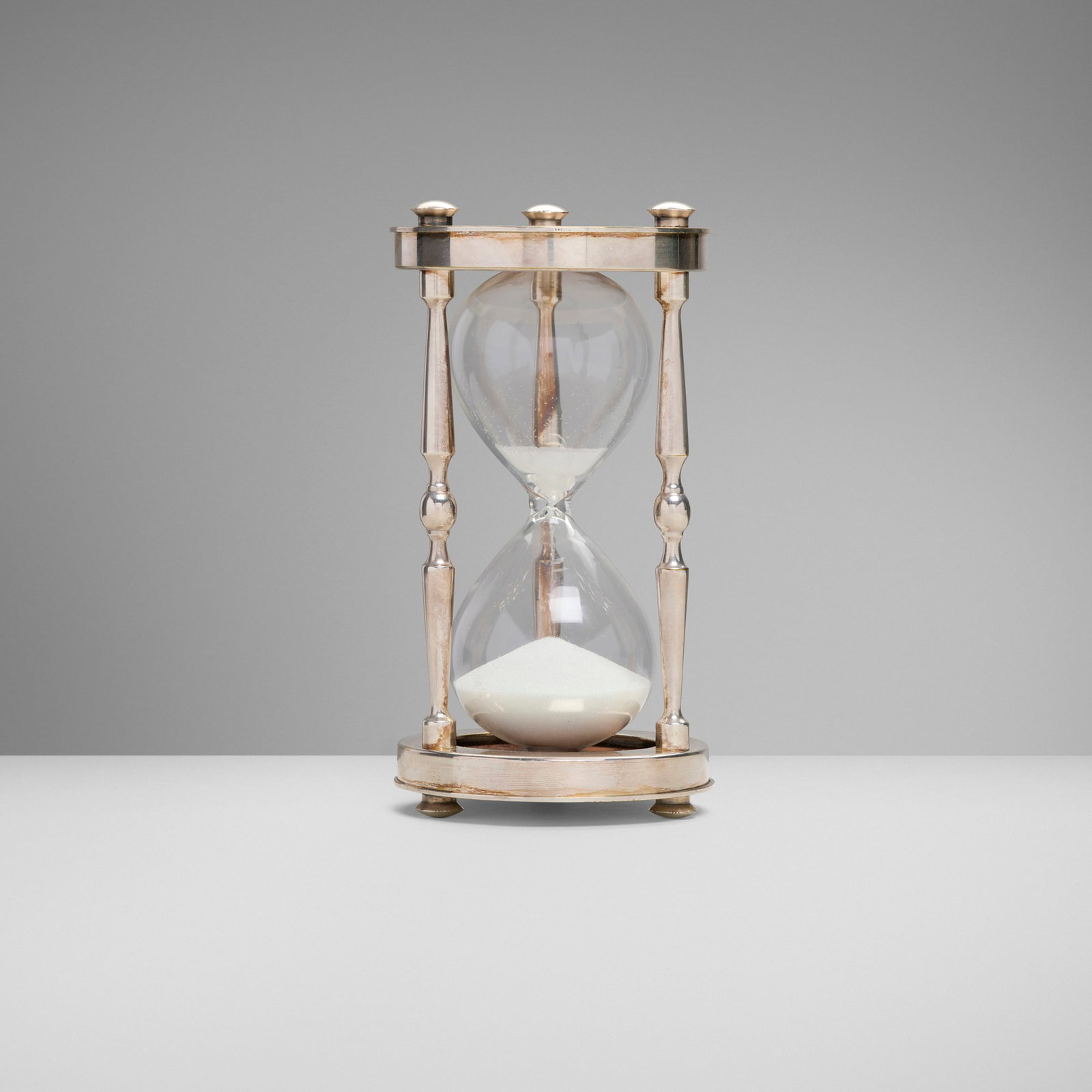 Christofle, Gallia hourglass: Christofle Gallia hourglass France, c. 1970 silver-plated brass, glass, wood, white silica 6.25 h x 3.25 dia in (16 x 8 cm) Impressed manufacturer's mark to underside 'Christofle France Coll-Gallia'.