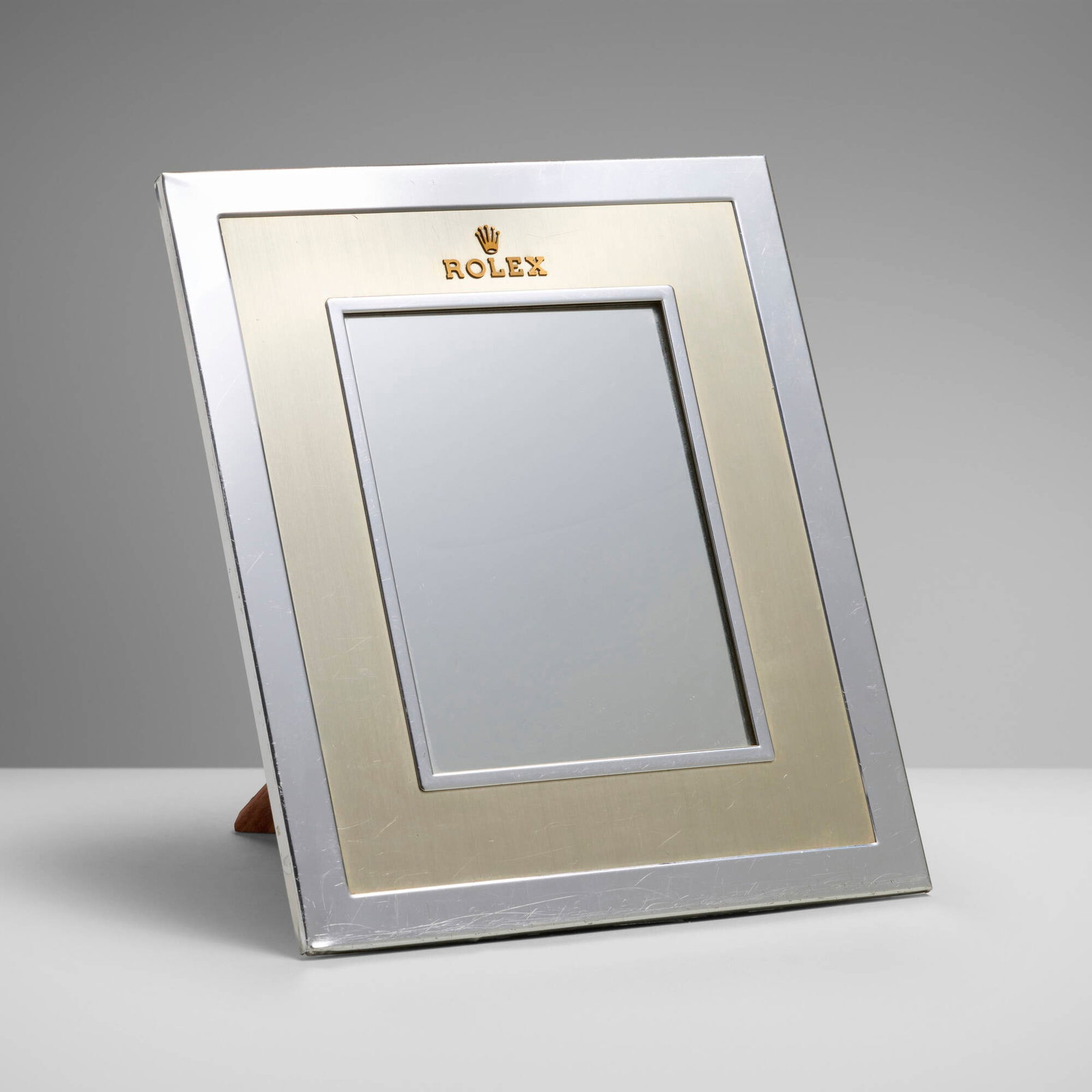 Rolex, Retailer display mirror: Rolex Retailer display mirror Switzerland, c. 1985 brushed and chrome-plated, mirrored glass 13.875 h x 12.875 w x 12.125 d in (35 x 33 x 31 cm) Raised manufacturer's mark to recto