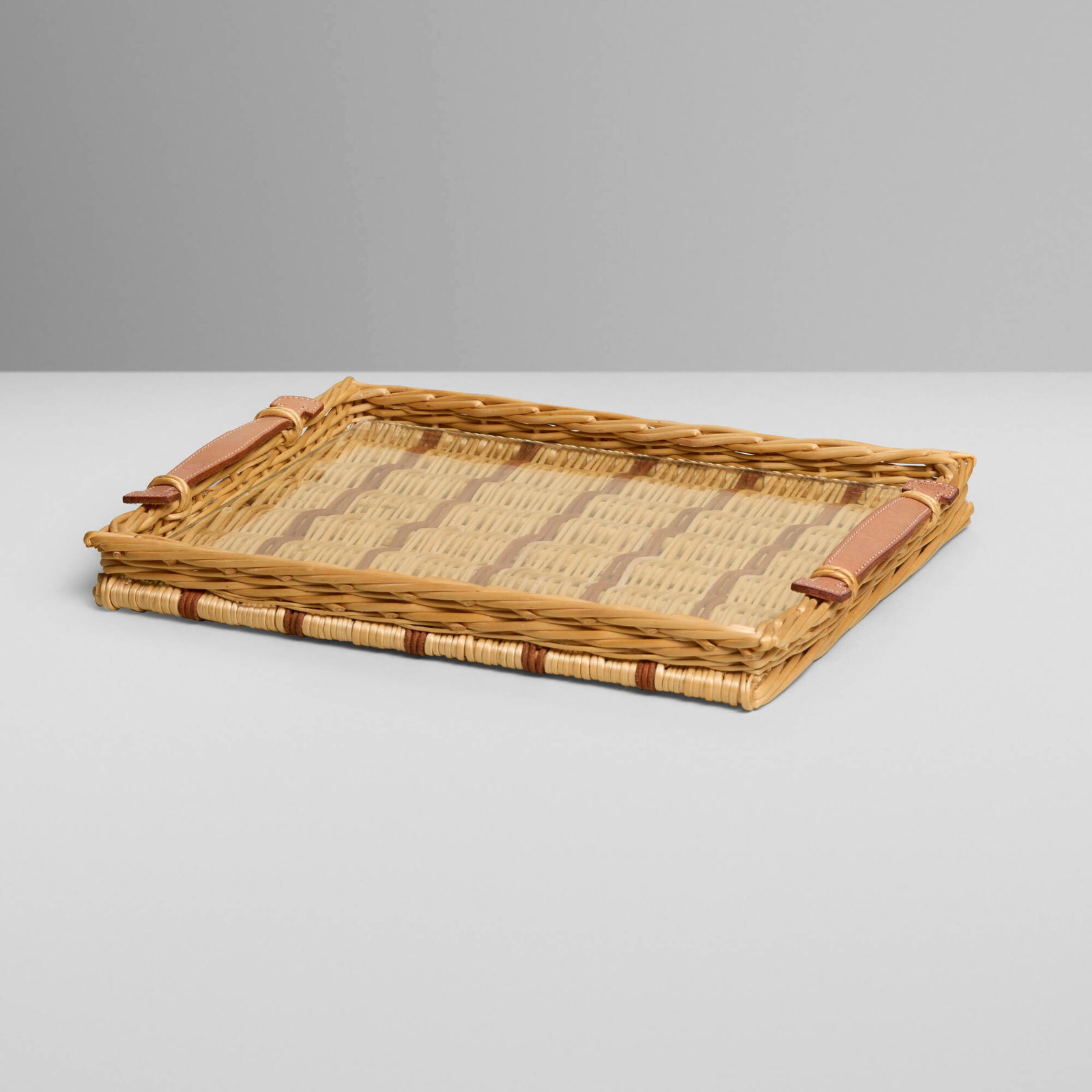 Hermes, Oseraie tray: Hermes Oseraie tray France, c. 2010 rattan, glass, leather 1.25 h x 11.5 w x 9 d in (3 x 29 x 23 cm) Embossed manufacturer's mark to handle 'Hermes'. This wor