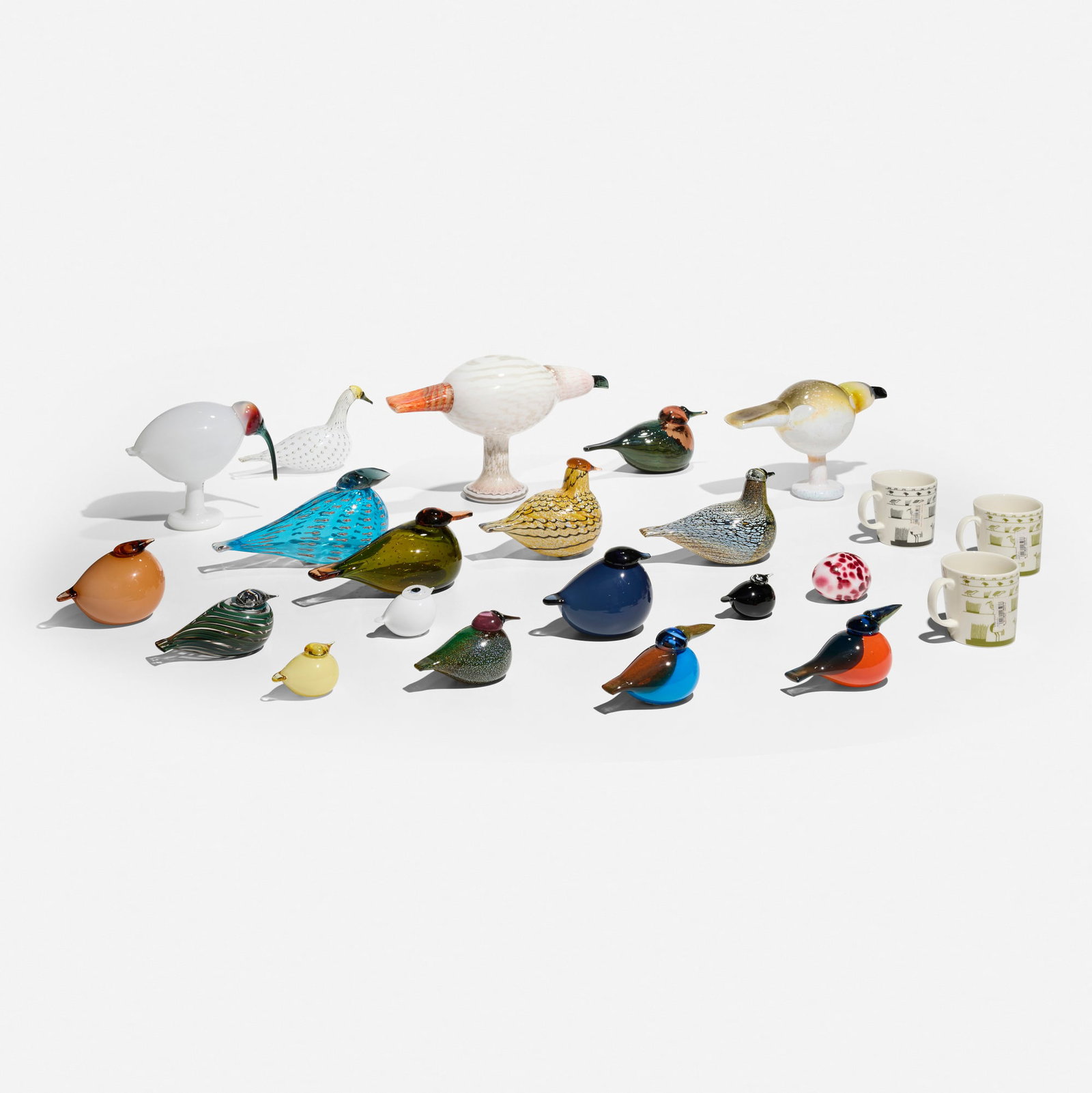 Oiva Toikka, Collection of eighteen birds, one egg, and three mugs: Oiva Toikka Collection of eighteen birds, one egg, and three mugs Finland, 1972 / 1999-2011 glass, screenprint in colors on ceramic largest: 7.75 h x 6 w x 13 d in (20 x 15 x 33 cm) smallest: 1.875 h