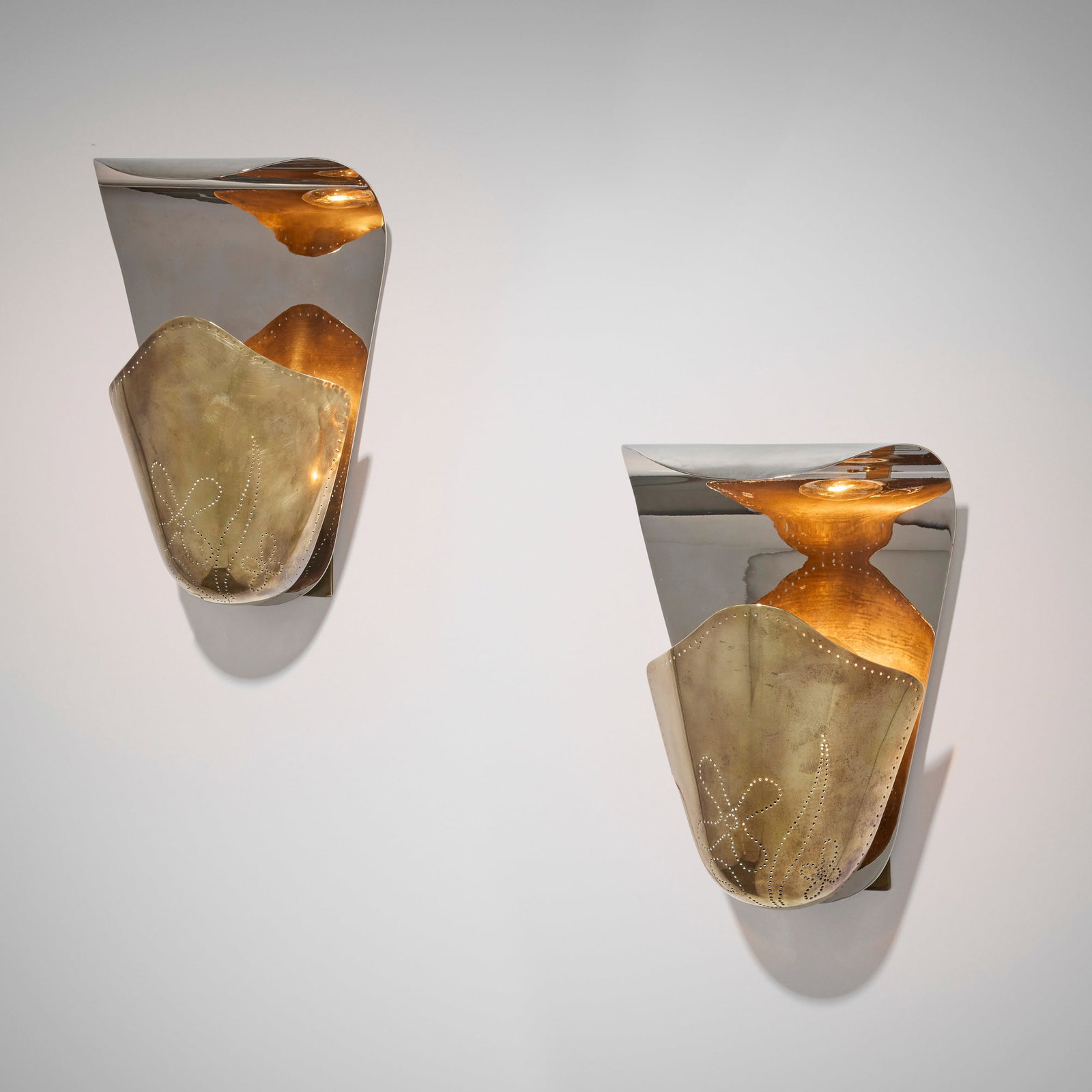 Harald Notini, Sconces model 8596, pair: Harald Notini Sconces model 8596, pair Bohlmarks Sweden, c. 1945 perforated brass 12.5 h x 8.375 w x 5 d in (32 x 21 x 13 cm) Provenance: Private Collection This work will ship from Chicago, Illinois.