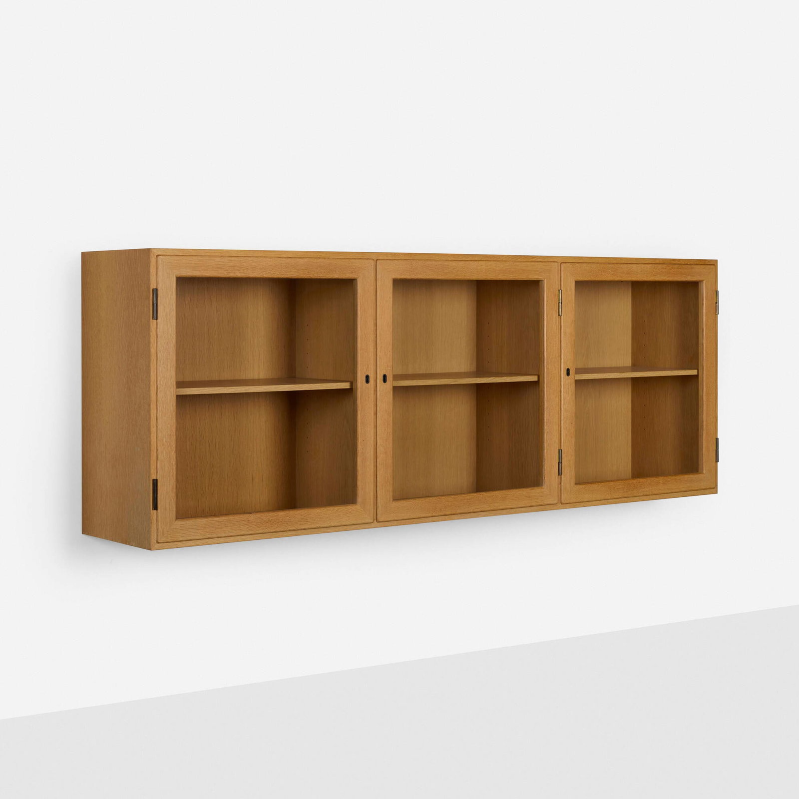 Borge Mogensen, Wall-mounted cabinet: Borge Mogensen Wall-mounted cabinet Soborg Mobelfabrik Denmark, c. 1970 oak, glass, brass 23.5 h x 64.5 w x 12 d in (60 x 164 x 30 cm) Cabinet features three lockable doors and three adjustable