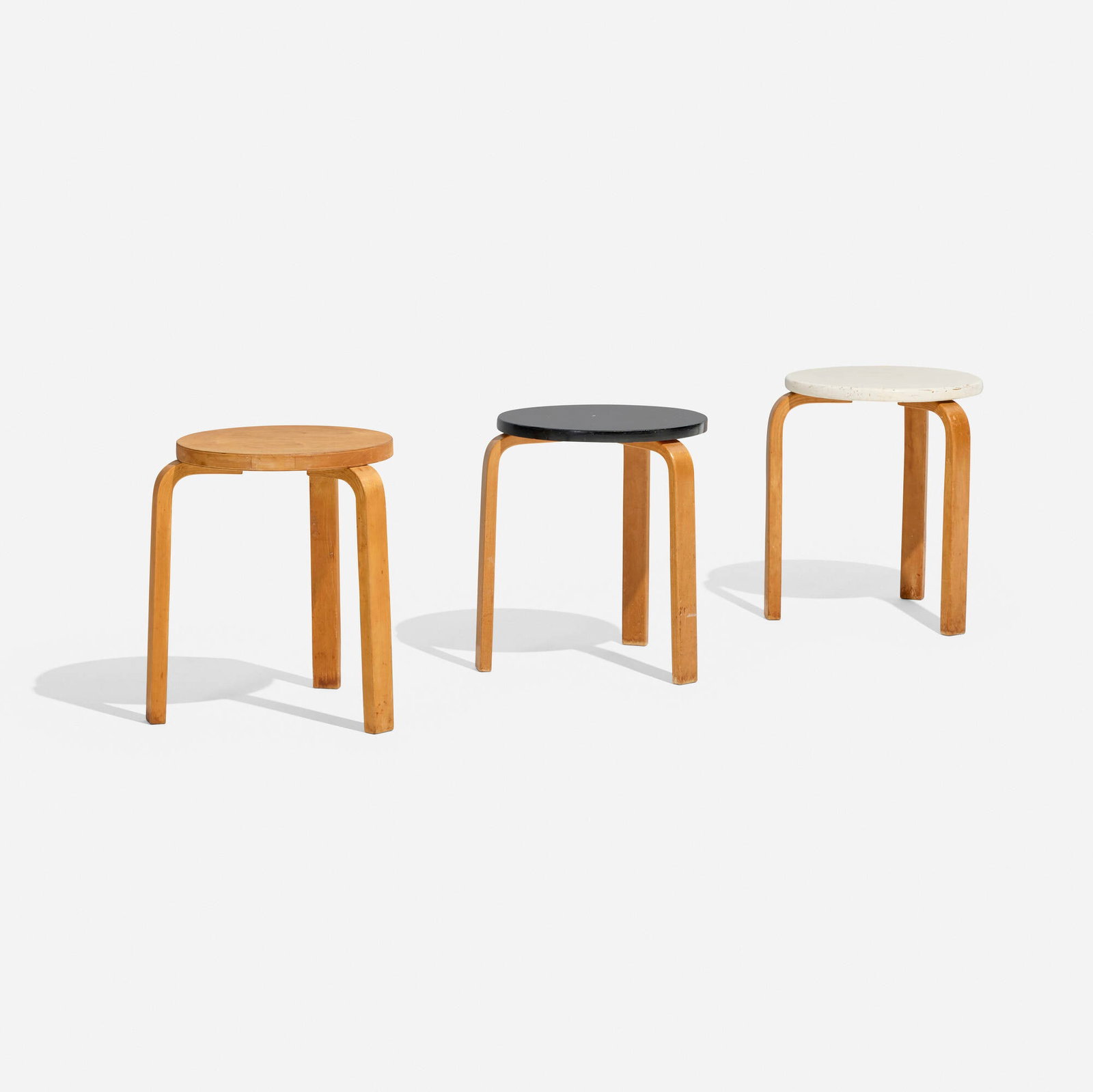 Alvar Aalto, L-leg stools model 60, set of three: Alvar Aalto L-leg stools model 60, set of three Artek Finland, 1933 lacquered birch, birch 17.5 h x 16 dia in (44 x 41 cm) Literature: Alvar Aalto: Designer, Lahti, pg. 169 This work will ship from