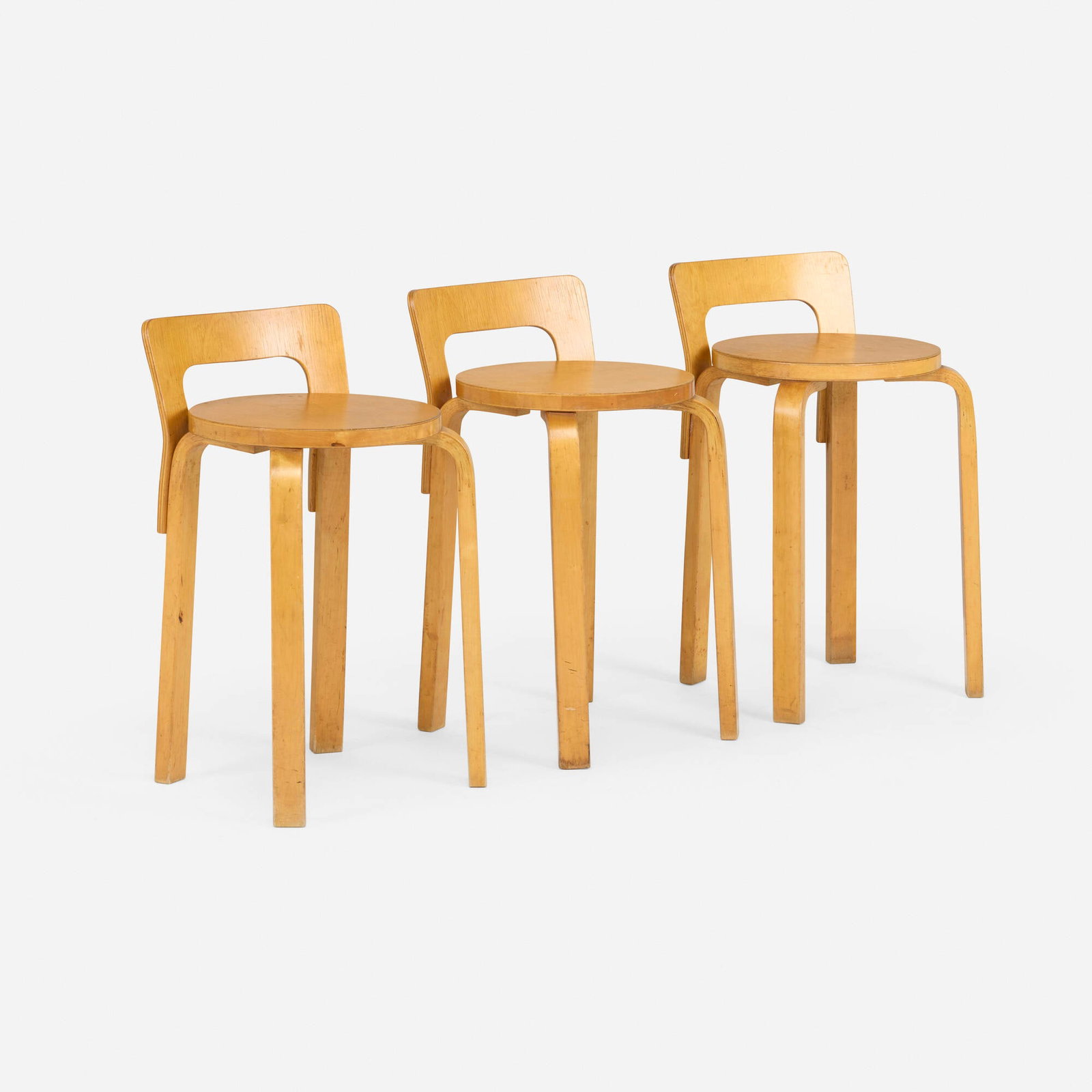 Alvar Aalto, L-leg stools, set of three: Alvar Aalto L-leg stools, set of three Artek Finland, 1934-1936 / c. 1950 laminated birch, birch 25.5 h x 13.5 w x 13 d in (65 x 34 x 33 cm) Partial paper distributor's label to underside two