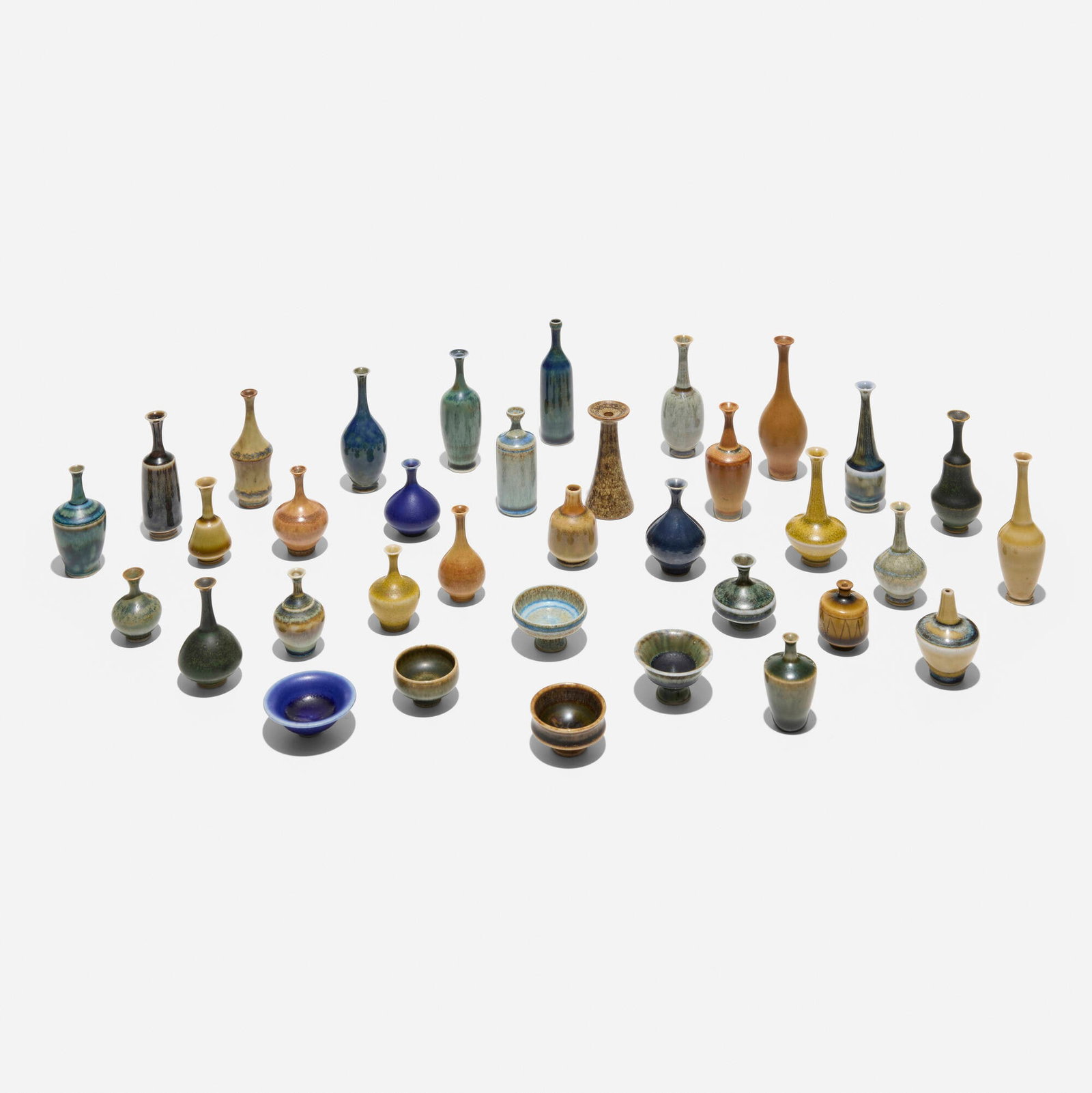John Andersson, Collection of thirty-five miniature vases: John Andersson Collection of thirty-five miniature vases Hoganas Sweden, c. 1950 glazed stoneware largest: 2.5 h x 1 dia in (6 x 3 cm) smallest: 1.25 h x 0.75 dia in (3 x 2 cm) Incised signature and