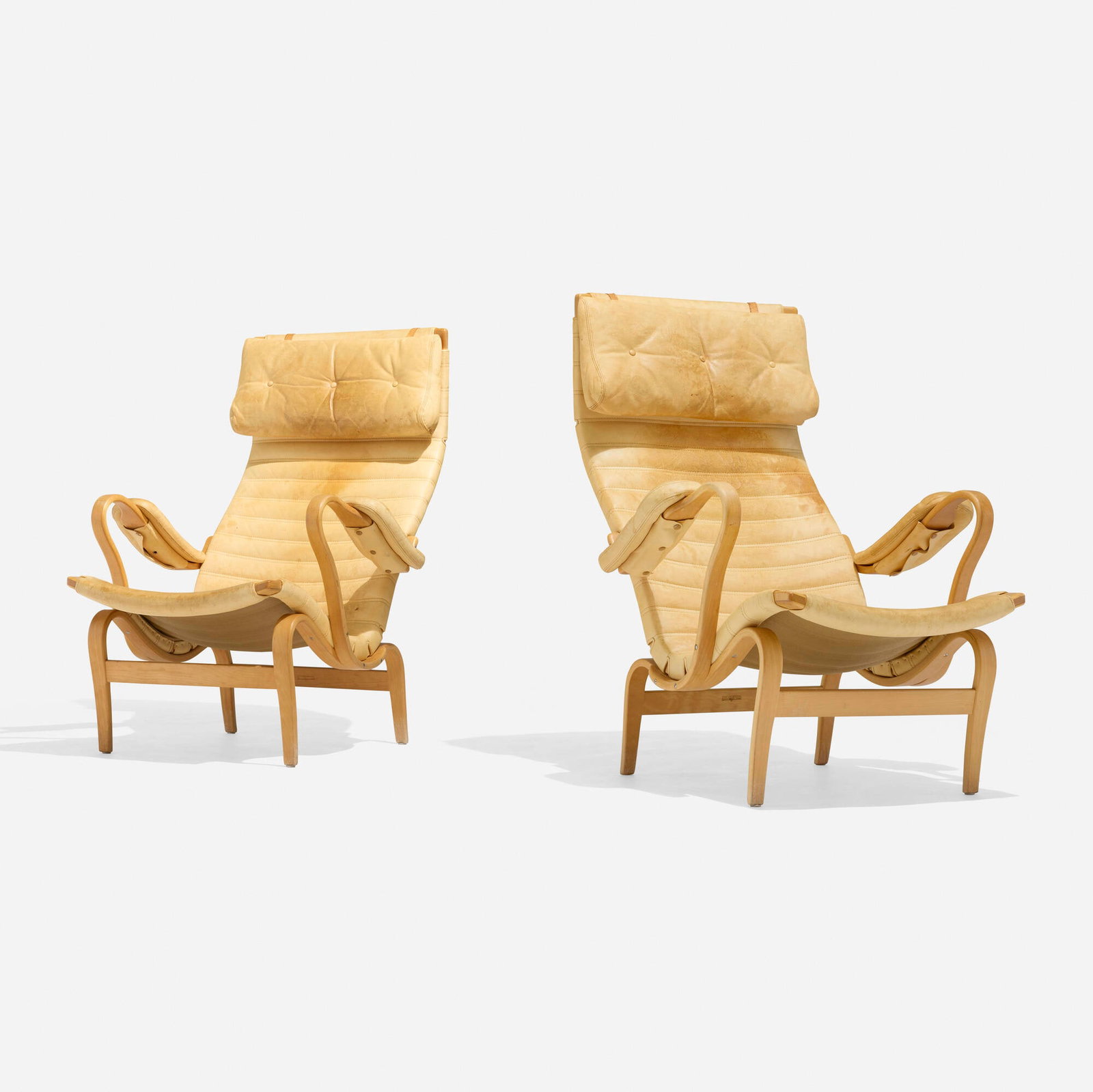 Bruno Mathsson, Pernilla 2 lounge chairs, pair: Bruno Mathsson Pernilla 2 lounge chairs, pair Firma Karl Mathsson Sweden, 1943 / 1977 laminated and steam-bent beech, leather upholstery 39.5 h x 28.75 w x 34 d in (100 x 73 x 86 cm) Brand