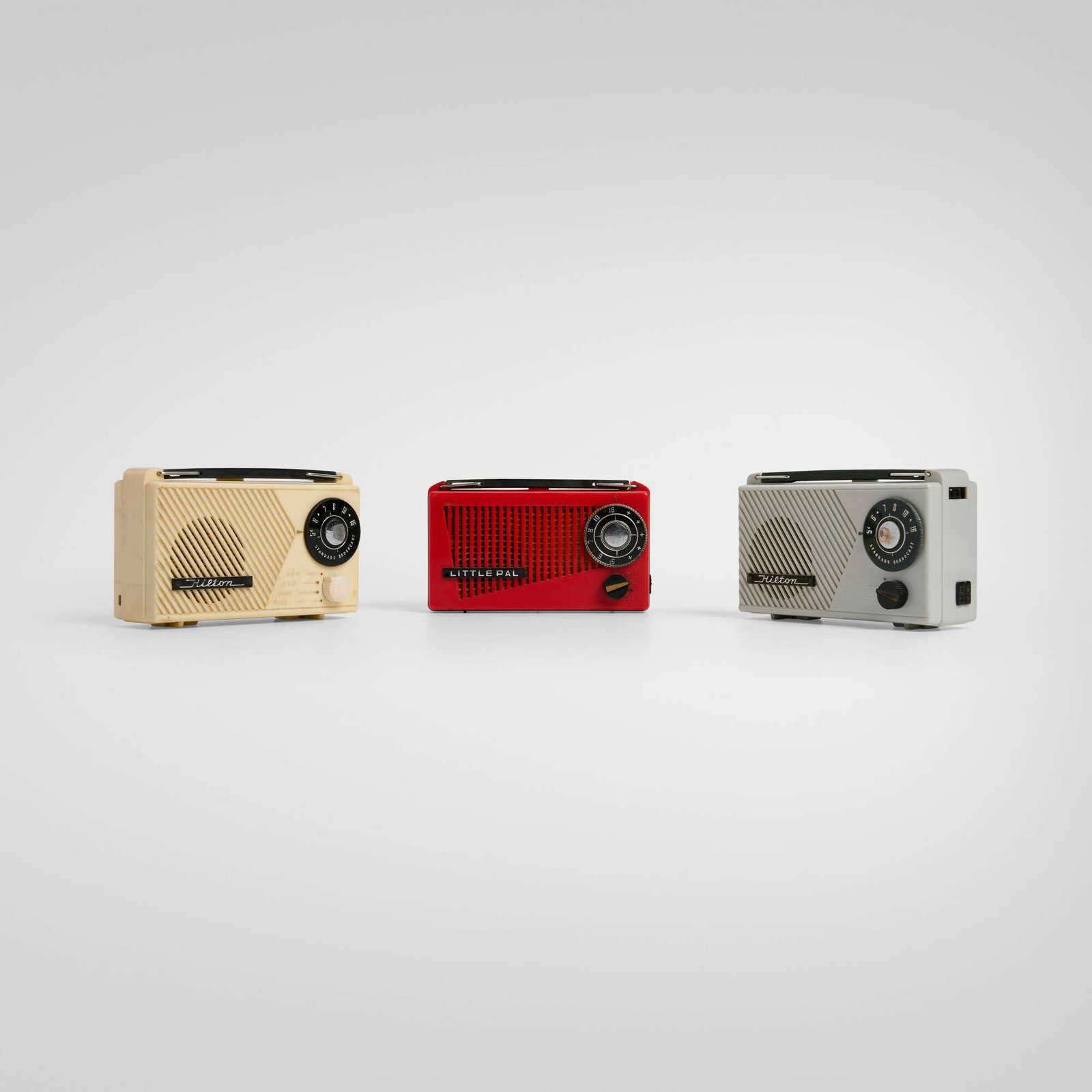 Japanese, Collection of three transistor radios: Japanese Collection of three transistor radios c. 1955 plastic, zinc-plated steel 3.75 h x 6 w x 2.25 d in (10 x 15 x 6 cm) Collection is comprised of two Hilton portable radios, model GW-3672 by