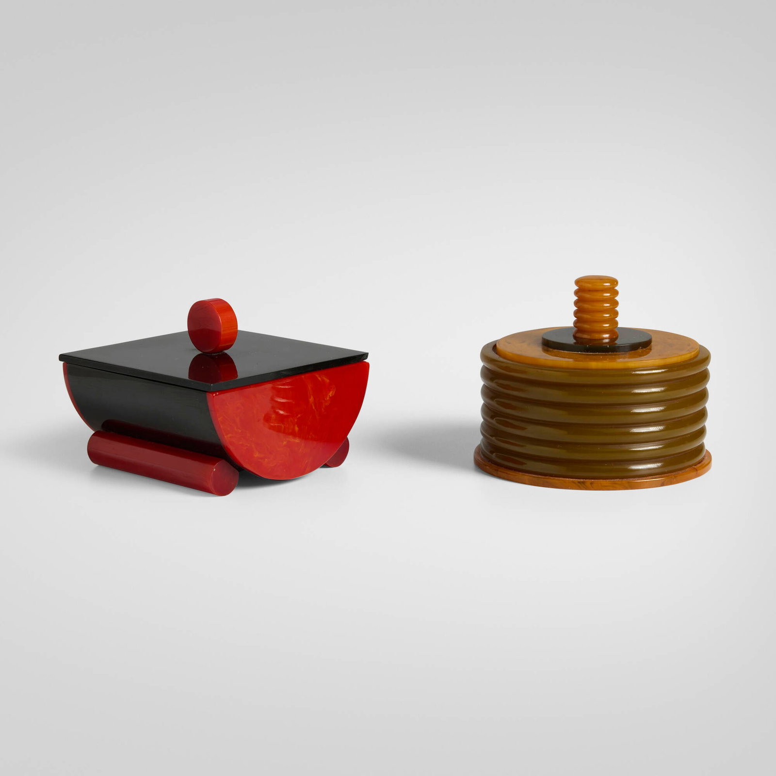 Art Deco, Covered boxes, set of two: Art Deco Covered boxes, set of two c. 1930 Catalin, Bakelite 2.5 h x 3.25 dia in (6 x 8 cm) 2.25 h x 3.125 w x 2.875 d in (6 x 8 x 7 cm) Provenance: Private Collection This work will ship from