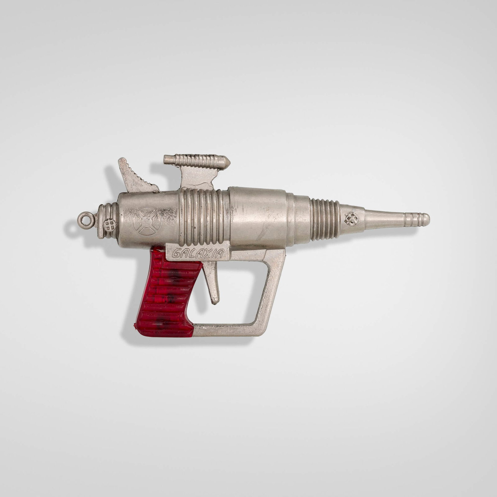 Redondo, Galaxia miniature space ray gun keychain: Redondo Galaxia miniature space ray gun keychain Spain, c. 1975 die-cast metal, plastic 1.875 h x 3.625 w x 0.75 d in (5 x 9 x 2 cm) Cast manufacturer's mark to side 'Galaxia Made in Spain