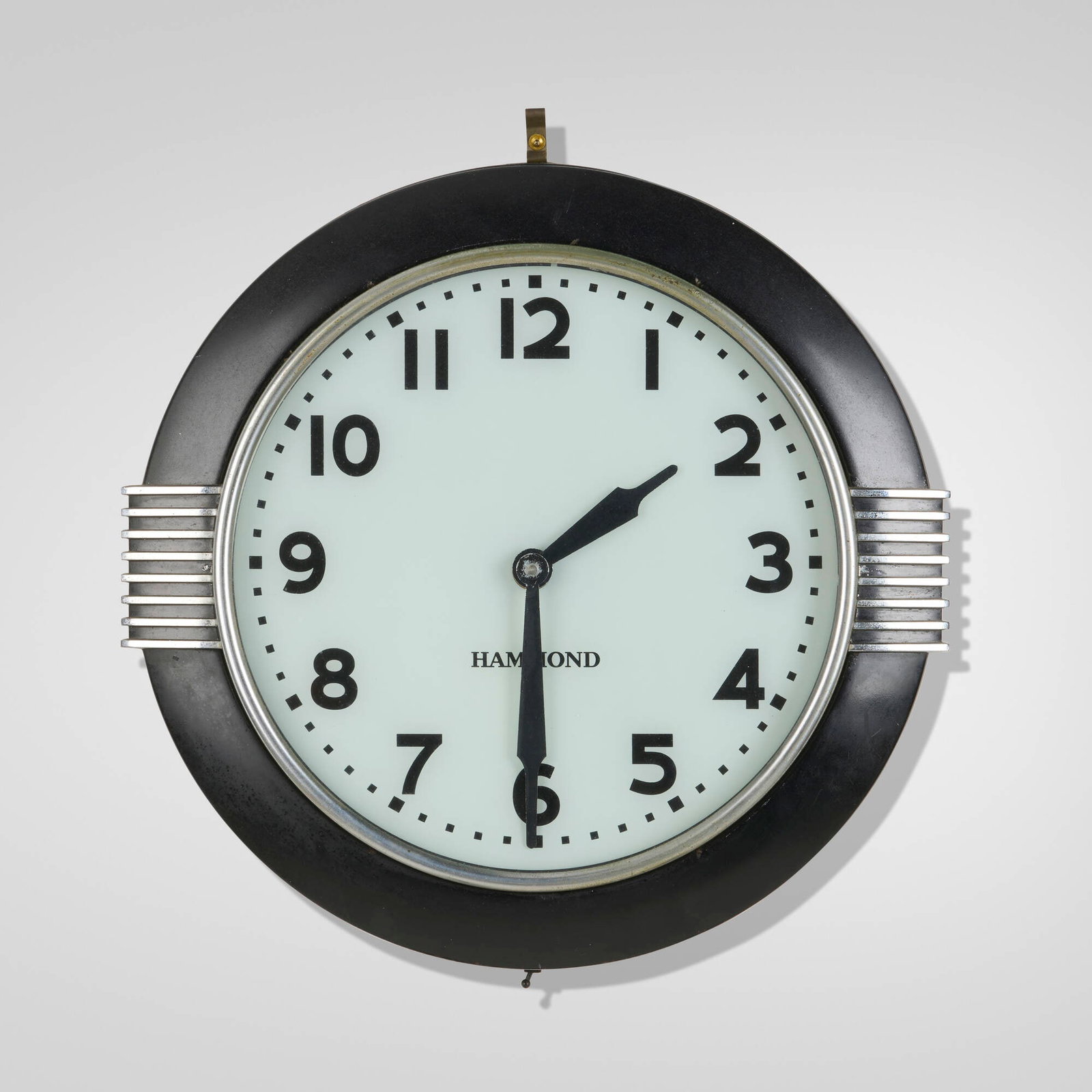 Hammond Instrument Co., Wall clock, model 341: Hammond Instrument Co. Wall clock, model 341 USA, c. 1935 chrome-plated steel, enameled steel, glass, lacquered wood 4 d x 20.5 dia in (10 x 52 cm) Printed manufacturer's mark to face