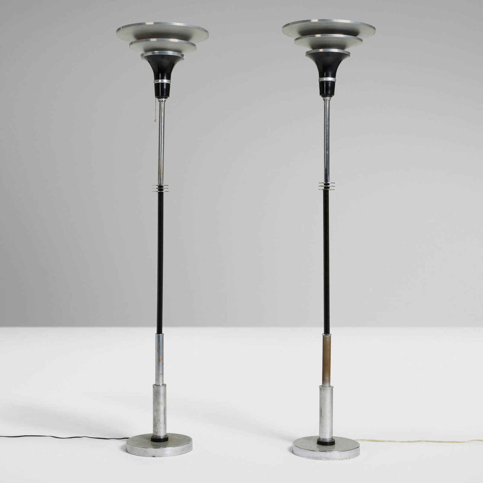 Machine Age, Floor lamps, pair: Machine Age Floor lamps, pair USA, c. 1935 chrome-plated and lacquered brass, aluminum 66.25 h x 14.125 dia in (168 x 36 cm) Provenance: Private Collection This work will ship from Chicago, Illinois.