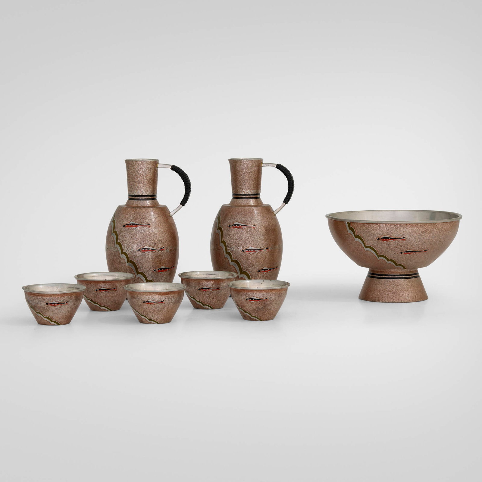 Japanese, Sake service with swimming fish: Japanese Sake service with swimming fish mid-20th century enameled tin, cane bowl: 2.625 h x 4.375 dia in (7 x 11 cm) pitcher: 4.5 h x 2.25 w x 2.75 d in (11 x 6 x 7 cm) cup: 1 h x 1.75 dia in (3 x 4