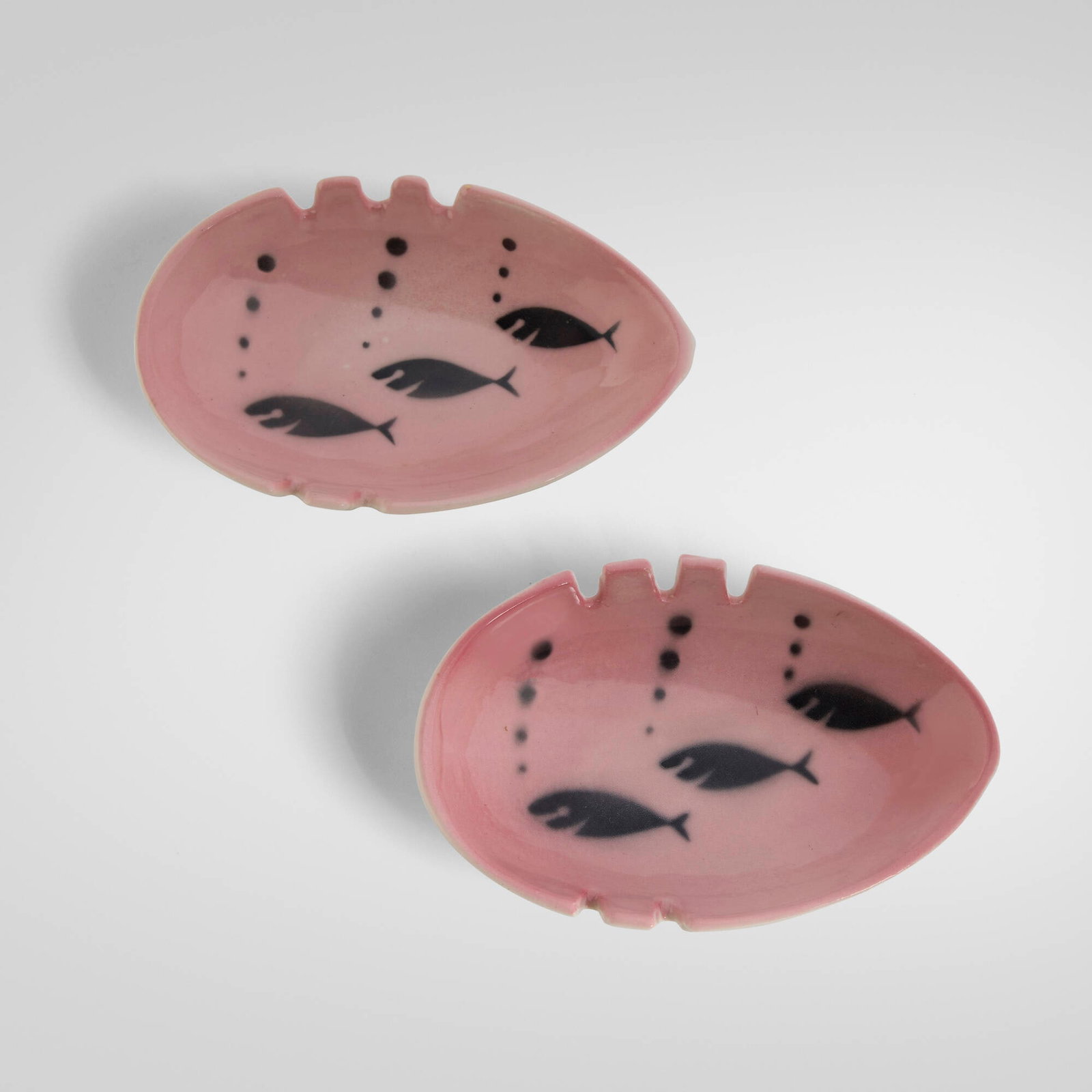 Mid-Century Modern, Ashtrays with swimming fish, pair: Mid-Century Modern Ashtrays with swimming fish, pair c. 1950 glazed stoneware 1.375 h x 6 w x 4 d in (3 x 15 x 10 cm) Provenance: Private Collection This work will ship from Chicago, Illinois.