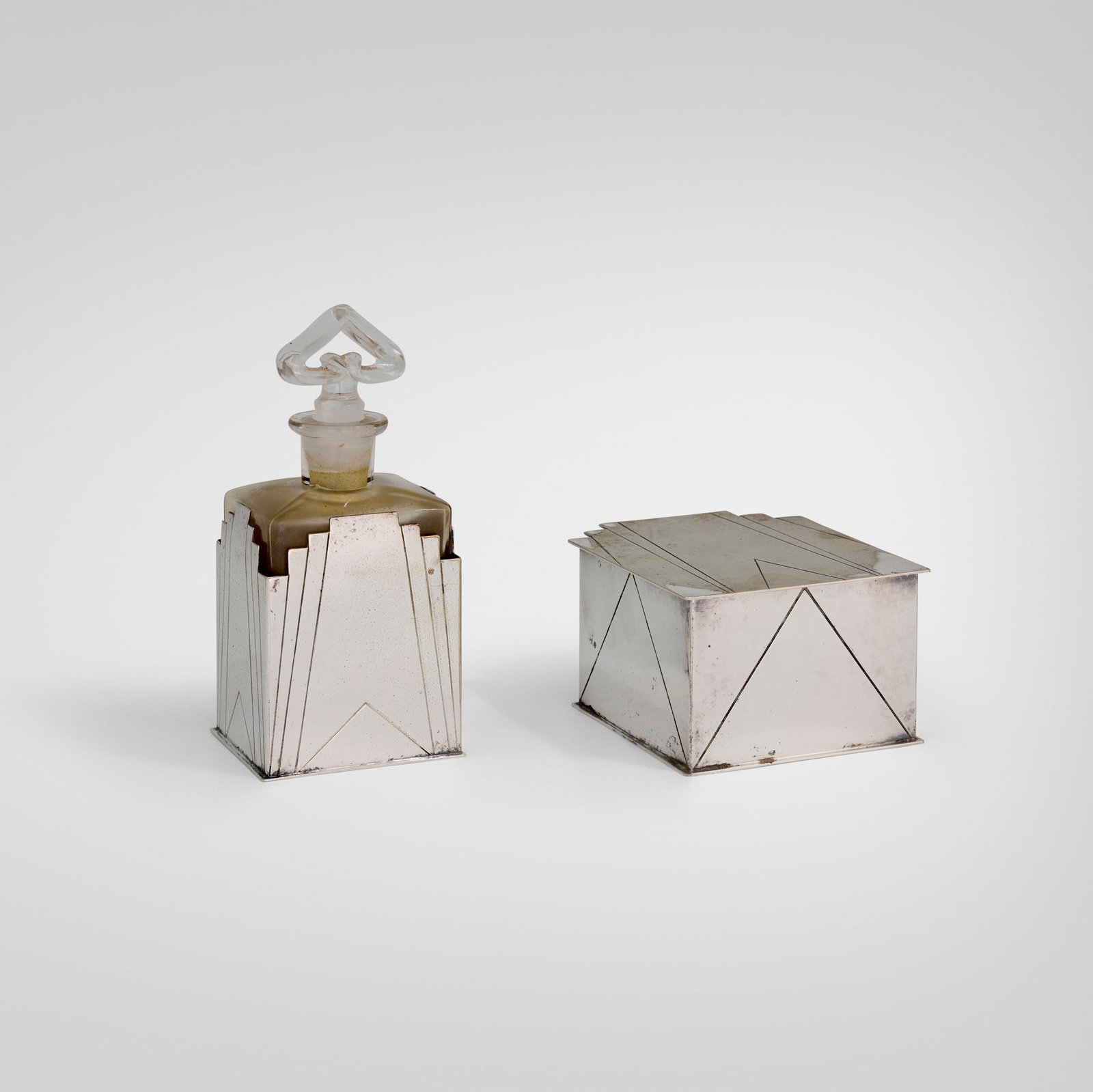 Louis W. Rice, Skyscraper vanity set: Louis W. Rice Skyscraper vanity set Apollo Studios USA, 1928 silver-plated brass, glass 6.5 h x 3 w x 2.5 d in (17 x 8 x 6 cm) 2.5 h x 3.875 w x 4.75 d in (6 x 10 x 12 cm) Set is comprised of a
