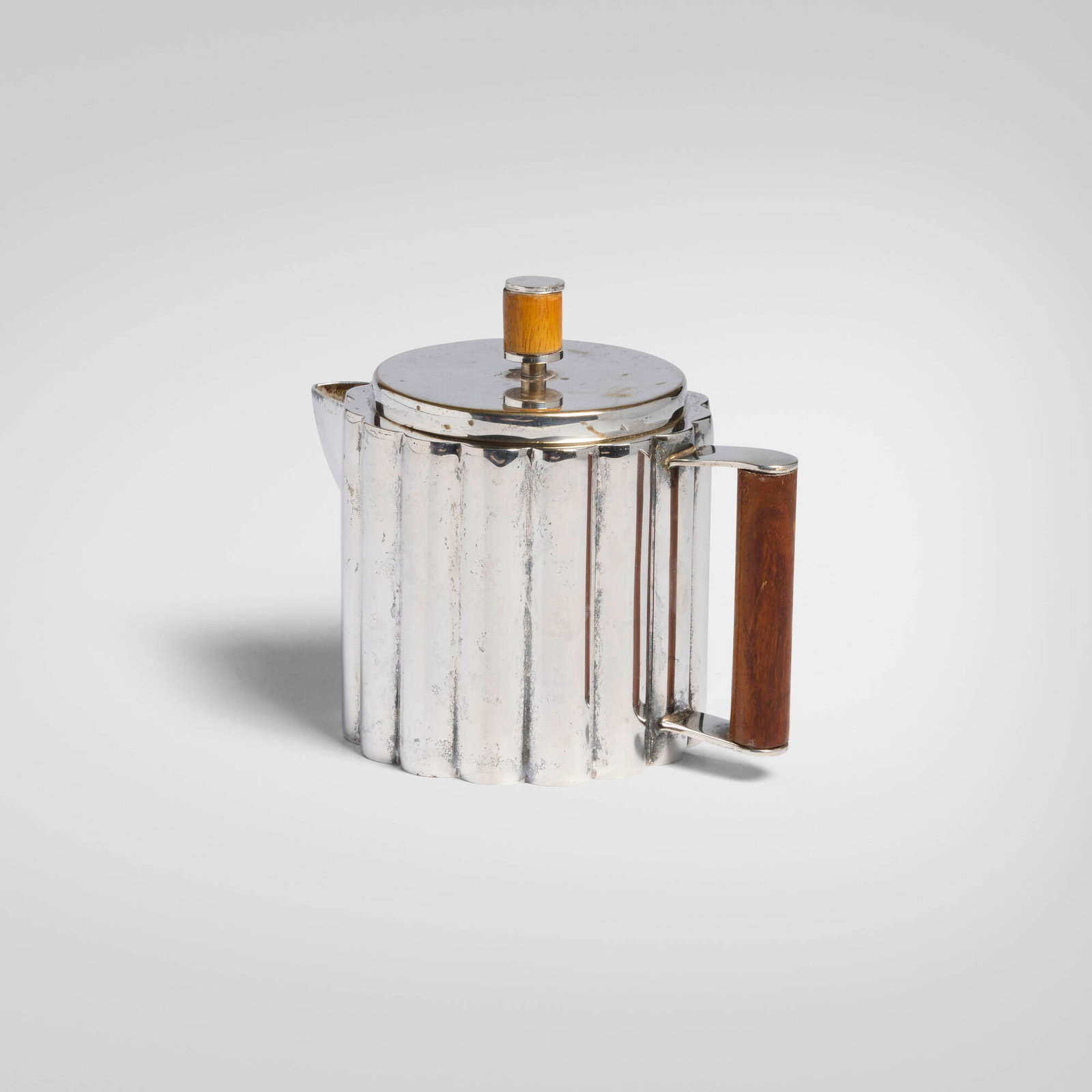 Ilonka Karasz, Teapot: Ilonka Karasz Teapot Paye & Baker Manufacturing Co. USA, c. 1928 electroplated nickel silver, walnut 5 h x 5.75 w x 3.75 d in (13 x 15 x 10 cm) Provenance: Private Collection Literature: Enchanting