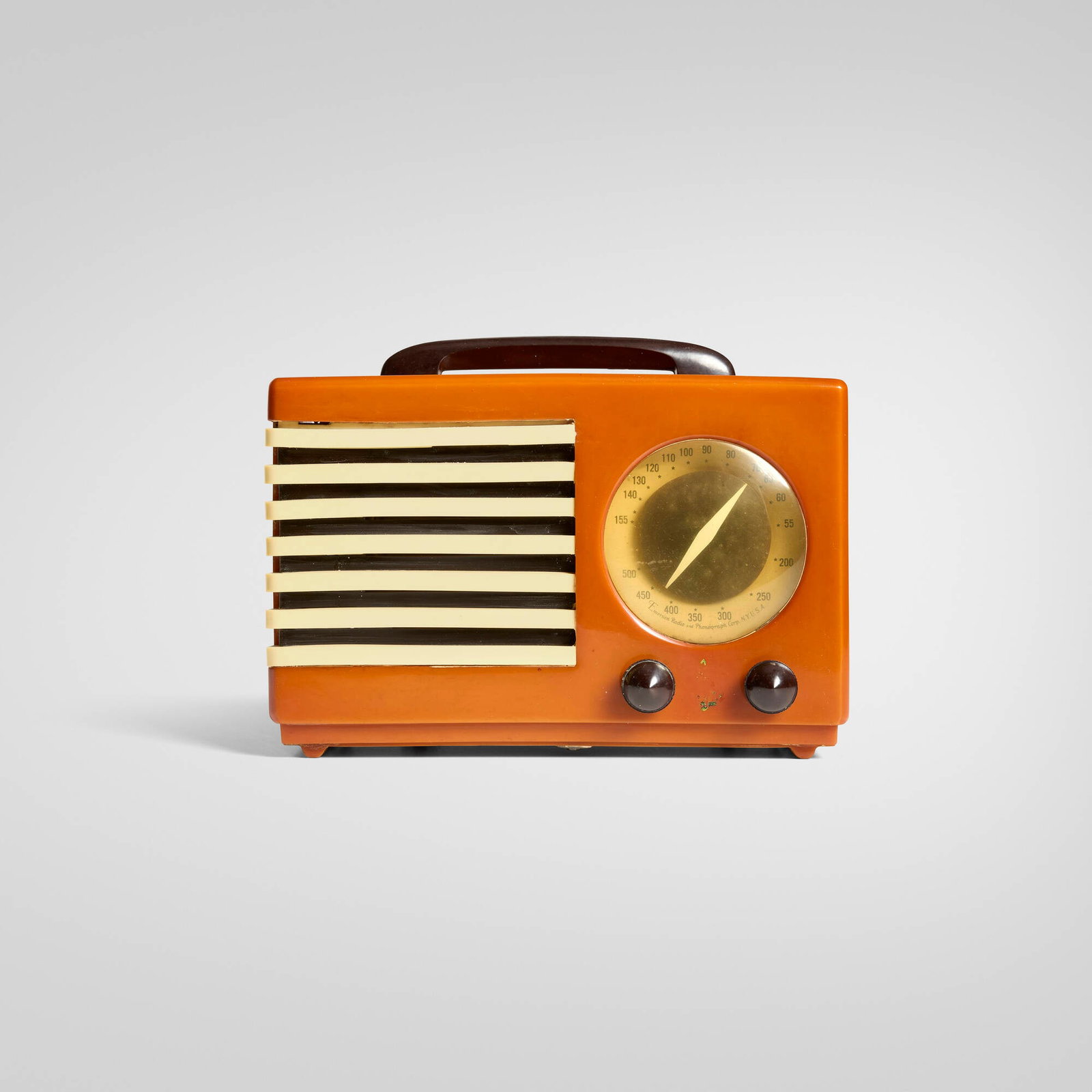 Norman Bel Geddes, Aristocrat radio, model FC 400: Norman Bel Geddes Aristocrat radio, model FC 400 Emerson Radio Co. USA, 1940 Catalin, plastic 8 h x 11 w x 6 d in (20 x 28 x 15 cm) Printed manufacturer's mark to dial 'Emerson Radio and