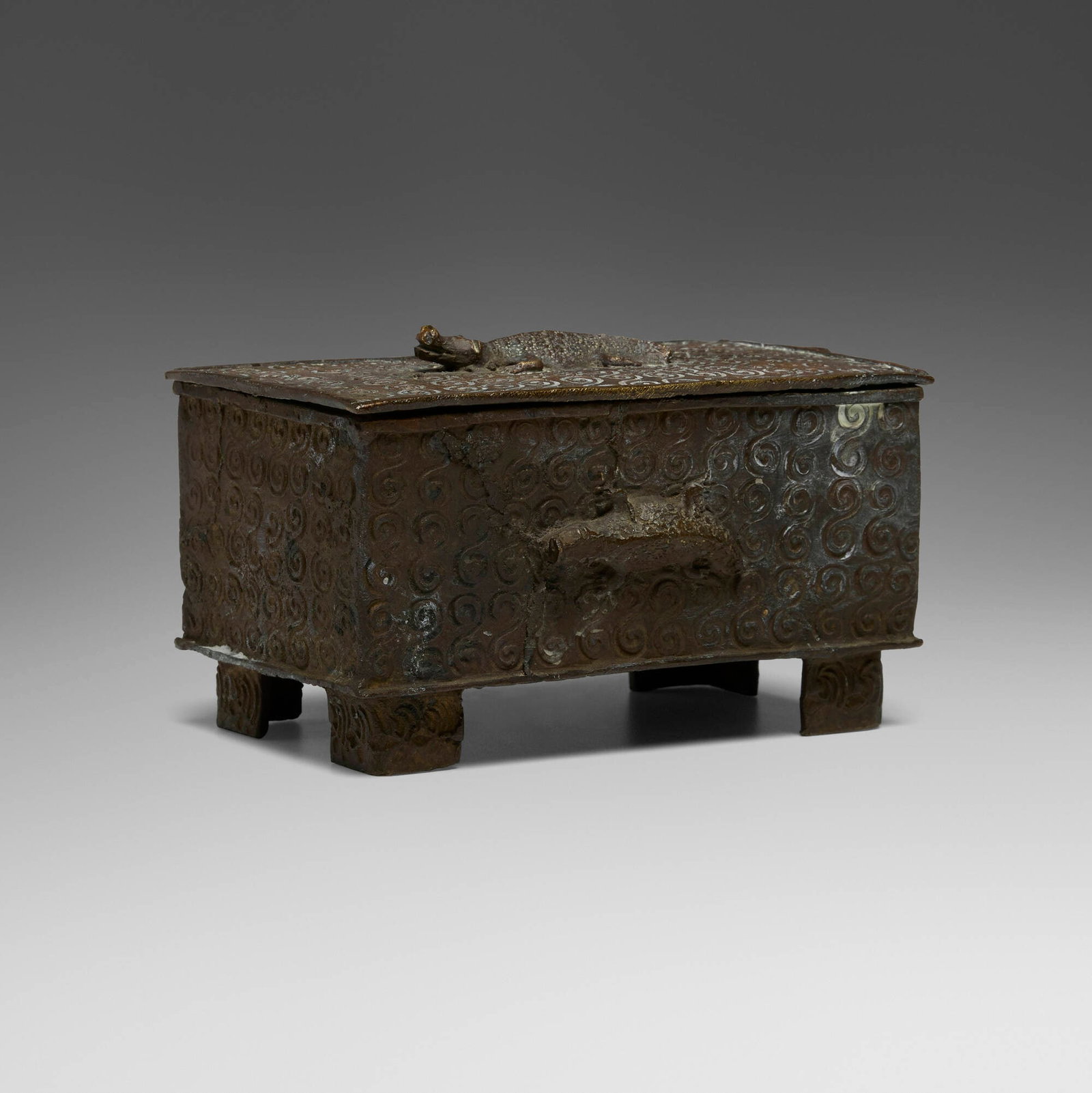 Asante (Ashanti), Abamphruwa (gold-dust box) with crocodiles: Asante (Ashanti) Abamphruwa (gold-dust box) with crocodiles Ghana, 19th century brass 3.25 h x 5.5 w x 3.25 d in (8 x 14 x 8 cm) This elegant rectangular container, raised on four feet, is ornamented
