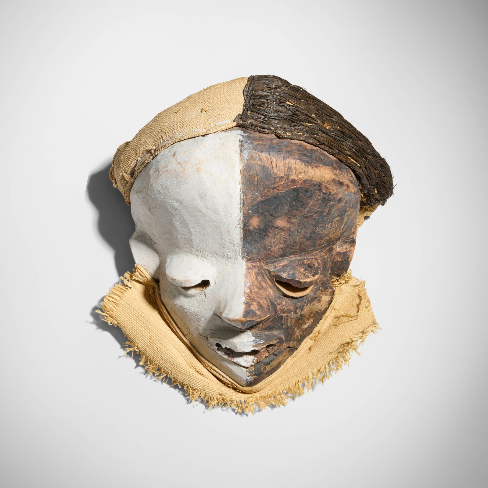 Pende, Mbangu mask: Pende Mbangu mask Democratic Republic of the Congo, 20th century carved and painted wood, raffia, burlap 5.5 h x 9 w x 7.5 d in (14 x 23 x 19 cm) Provenance: Collection of Elio