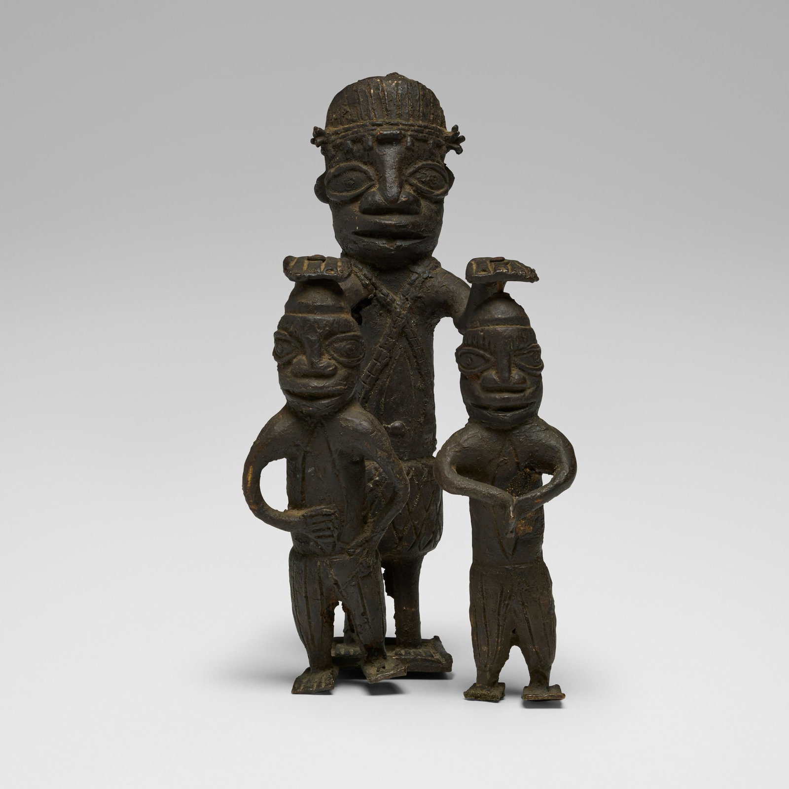 Benin, Figural group: Benin Figural group probably 19th century bronze 9 h x 3.5 w x 5 d in (23 x 9 x 13 cm) Provenance: Collection of Eliot Elisofon | Thence by descent This work will ship from Chicago, Illinois.