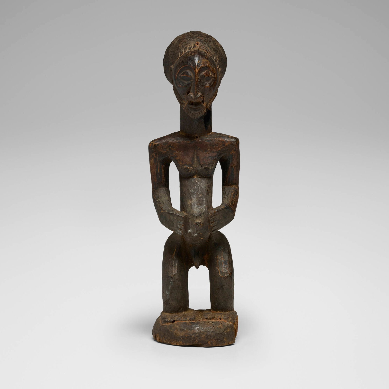 Hemba, Male figure: Hemba Male figure Democratic Republic of the Congo, 20th century carved wood 18.5 h x 5.5 w x 6 d in (47 x 14 x 15 cm) This work will ship from Chicago, Illinois.