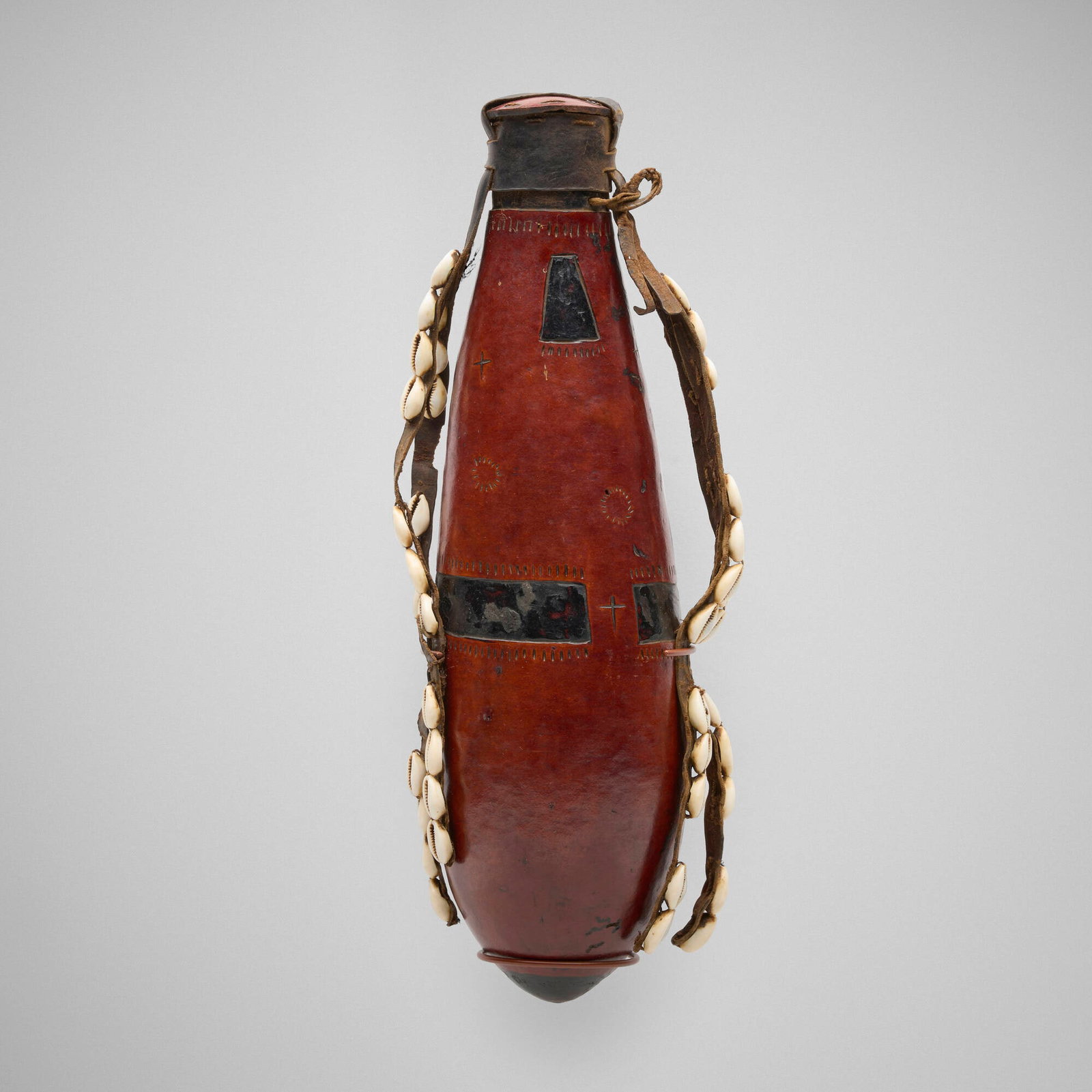 Nyaturu, Wedding gourd: Nyaturu Wedding gourd Tanzania, 20th century gourd, cowry shells, leather 17 h x 6 w x 6 d in (43 x 15 x 15 cm) Sold with a custom wall mount for display. Provenance: James Stephenson African Art,