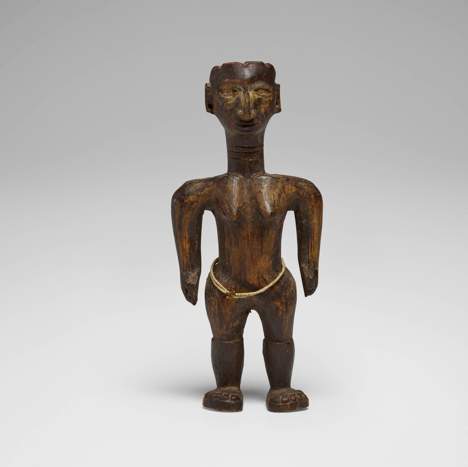 Kaguru, Standing female figure: Kaguru Standing female figure Tanzania, 20th century carved wood, beads 10 h x 4.5 w x 3 d in (25 x 11 x 8 cm) Provenance: Private Collection, Maryland This work will ship from Chicago, Illinois.