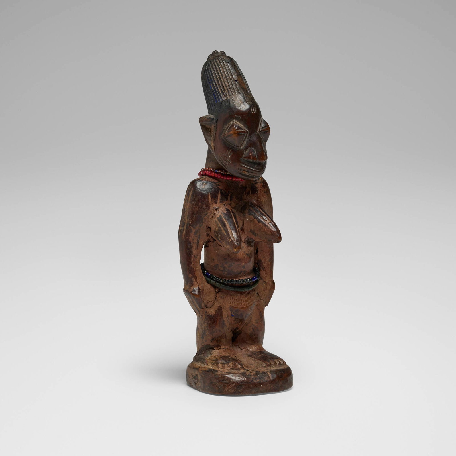Yoruba, Female Ere Ibeji (twin figure): Yoruba Female Ere Ibeji (twin figure) Oro, Igbomina Kingdom, Nigeria, late 19th / early 20th century carved wood, beads 10 h x 3.5 w x 2.75 d in (25 x 9 x 7 cm) Provenance: Jef