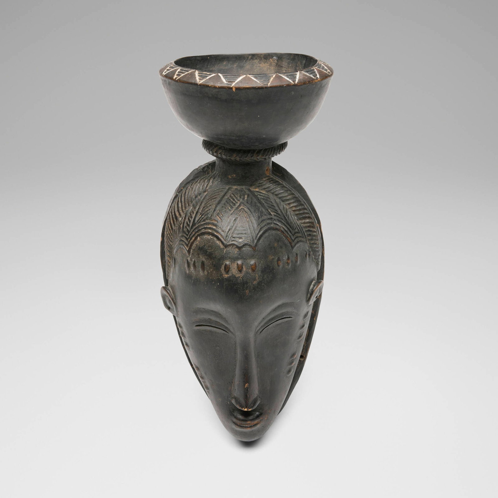 Guro, Mask surmounted by a bowl: Guro Mask surmounted by a bowl Cote d'Ivoire, late 19th century/early 20th century carved wood 13.5 h x 5.75 w x 5.75 d in (34 x 15 x 15 cm) Provenance: Pace Primitive, New York | Acquired from the