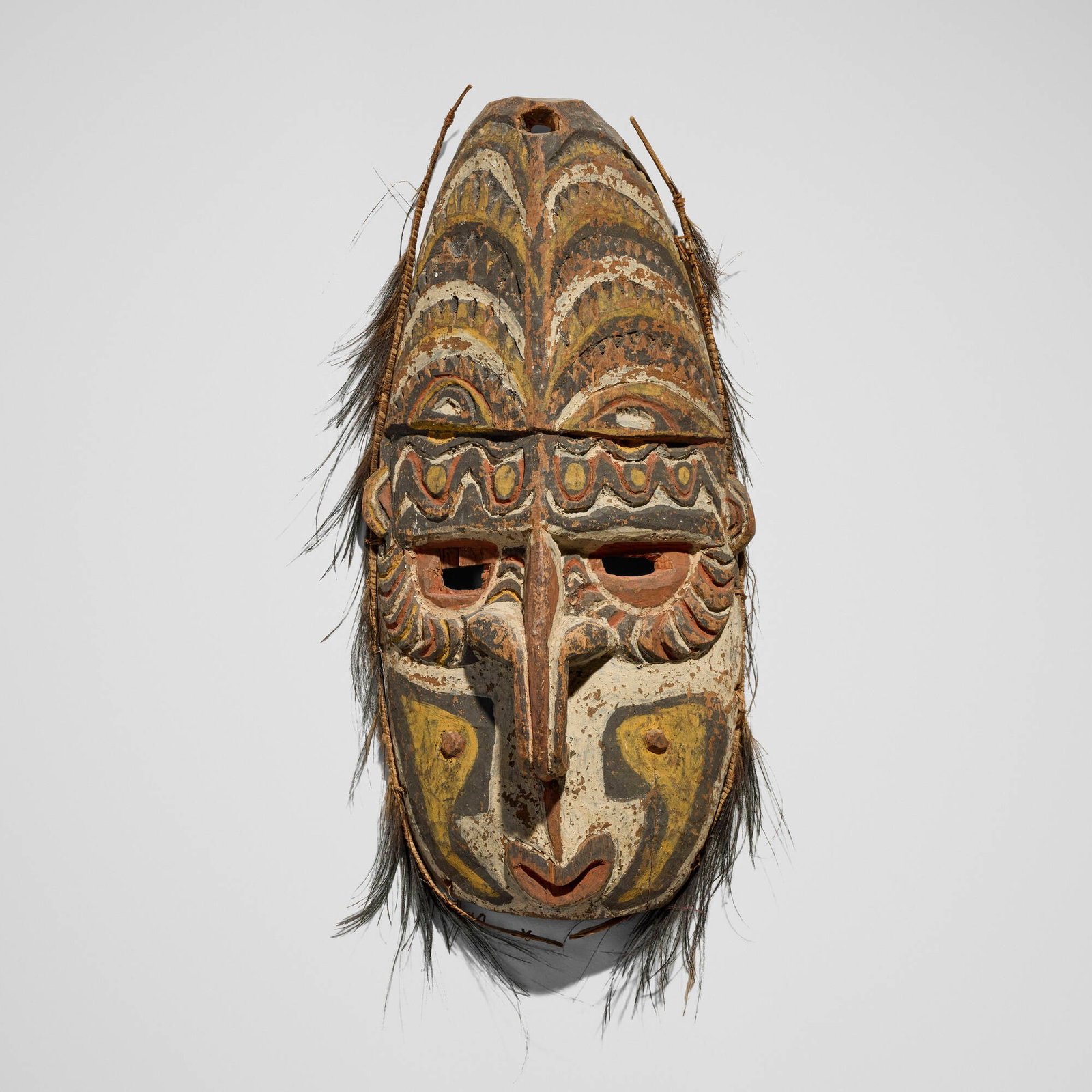 Sepik River, Ancestor mask: Sepik River Ancestor mask Papua New Guinea, 20th century carved wood, pigment, feathers, plant fibers 27 h x 12 w x 5.5 d in (69 x 30 x 14 cm) Provenance: Private Collection, S