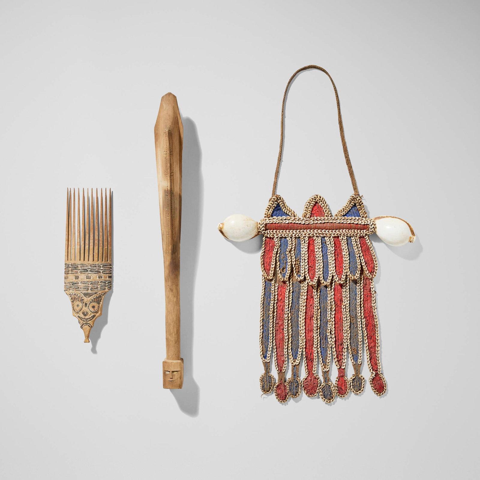 Papuan, Collection of three objects: Papuan Collection of three objects New Guinea, 20th century carved wood, woven and painted fiber, shells 20.5 h x 4 w x 2 d in (52 x 10 x 5 cm) 14 h x 14 w x 1.75 d in (36 x 36 x 4 cm) 7 h x 3.75 w x