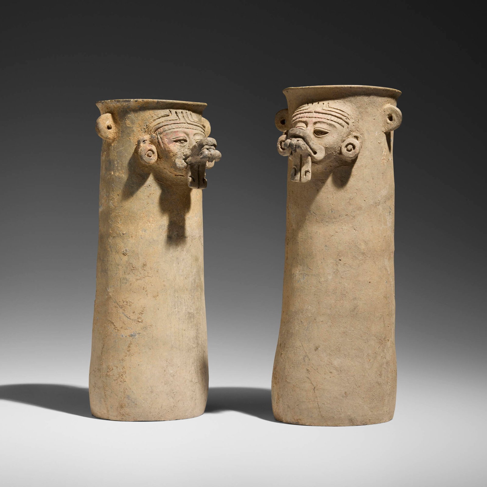 Zapotec, Monte Alban IIIA Cylindrical vases, pair: Zapotec Monte Alban IIIA Cylindrical vases, pair Monte Alban, Valley of Oaxaca, Early Classic, c. 200-400 CE earthenware with traces of pigment 12 h x 5.5 w x 6 d in (30 x 14 x 15 cm) 11.5 h x 5.5 w