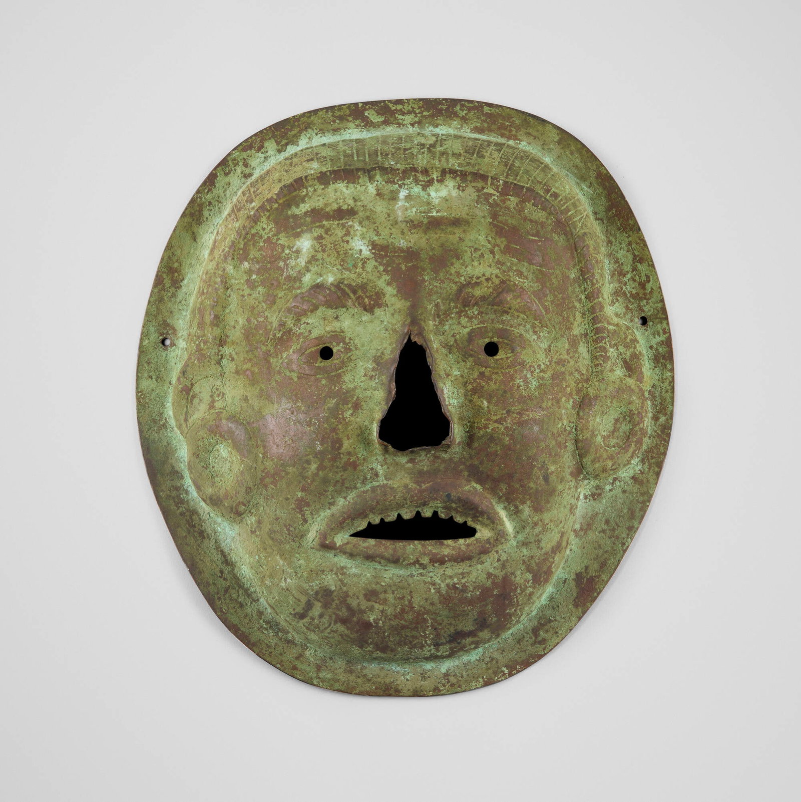 Moche, Mask: Moche Mask Peru, c. 300 - 700 CE copper 11.75 h x 10.5 w x 2.5 d in (30 x 27 x 6 cm) Provenance: Estate of Paul A. Cohen, Massachusetts This work will ship from Lambertville, New Jersey.