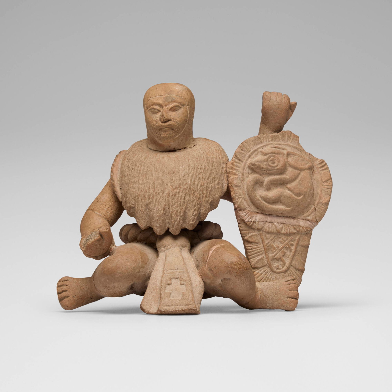Veracruz, Crouching warrior with shield: Veracruz Crouching warrior with shield Mexico, Late Classic, c. 550-950 CE earthenware 4.75 h x 5.75 w x 3.25 d in (12 x 15 x 8 cm) Sold with a copy of the Sotheby Parke Bernet auction catalog