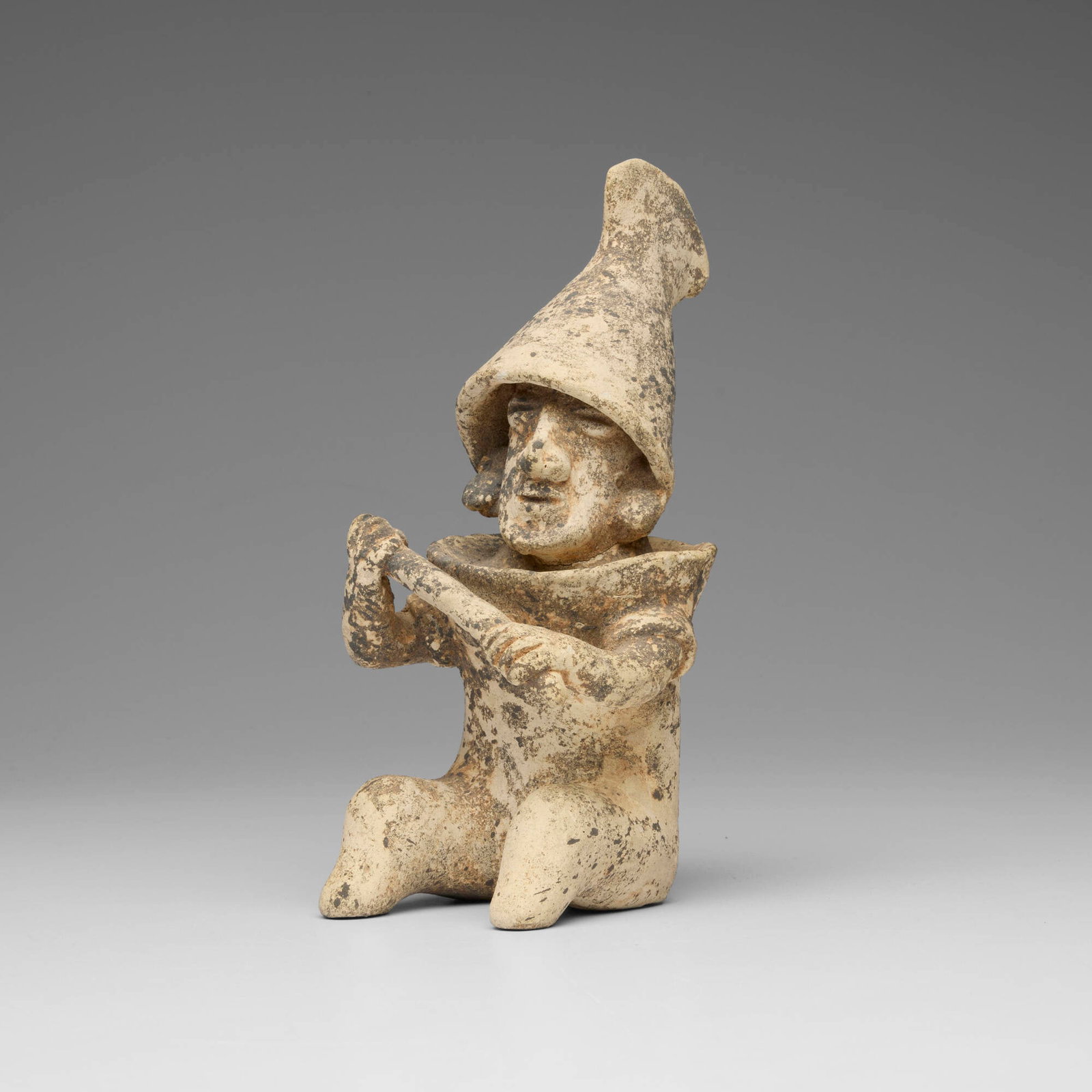 Jalisco, Seated figure: Jalisco Seated figure Protoclassic, c. 100 BCE-250 CE earthenware 9.5 h x 4.375 w x 5.875 d in (24 x 11 x 15 cm) Provenance: Edward H. Merrin Gallery, New York | Acquired from the previous in 1971,