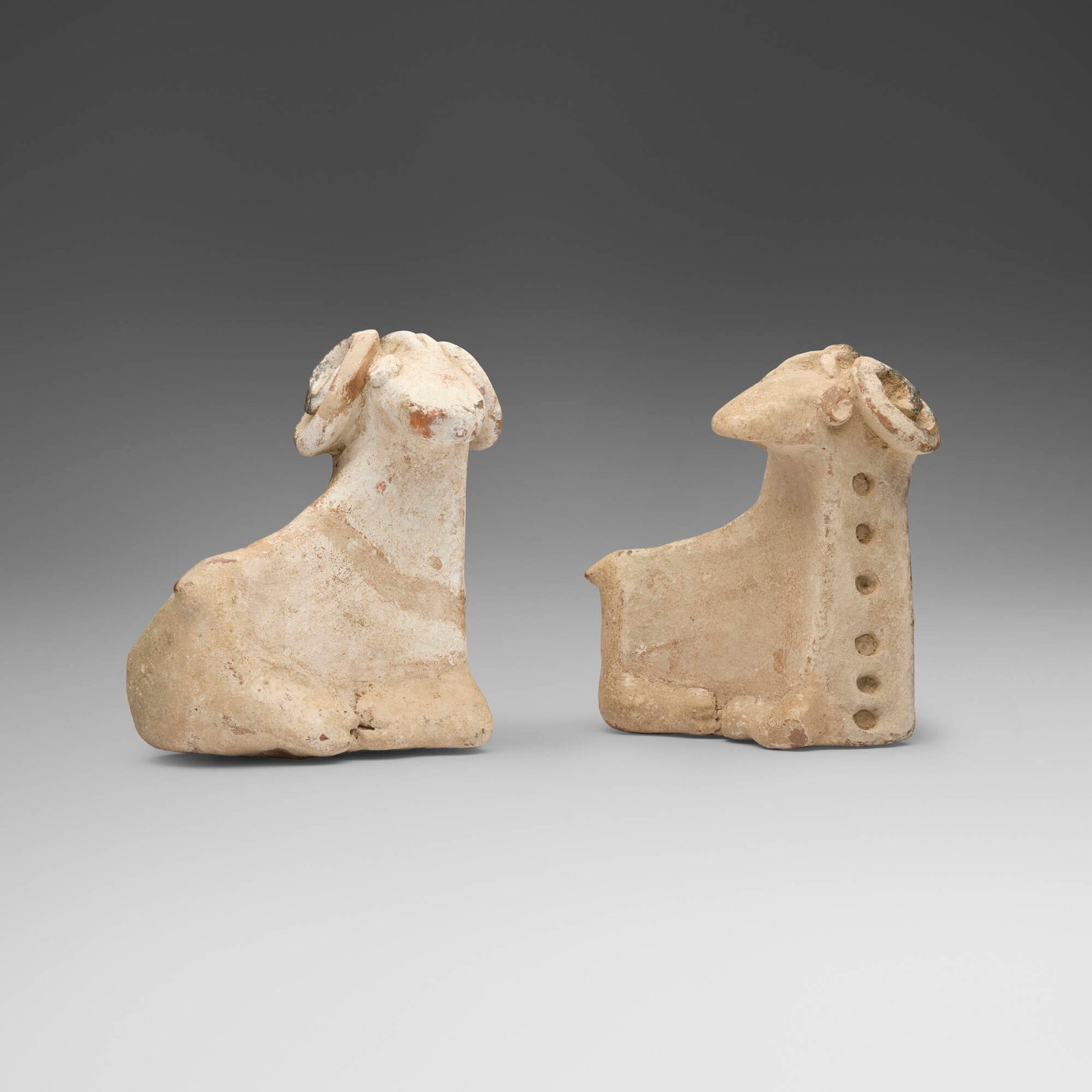 Khurvin, Reclining rams, pair: Khurvin Reclining rams, pair Iran, c. 1000 BCE earthenware 8.5 h x 8.125 w x 5.125 d in (22 x 21 x 13 cm) 8.25 h x 8.125 w x 5 d in (21 x 21 x 13 cm) Sold with a digital copy of the original invoice