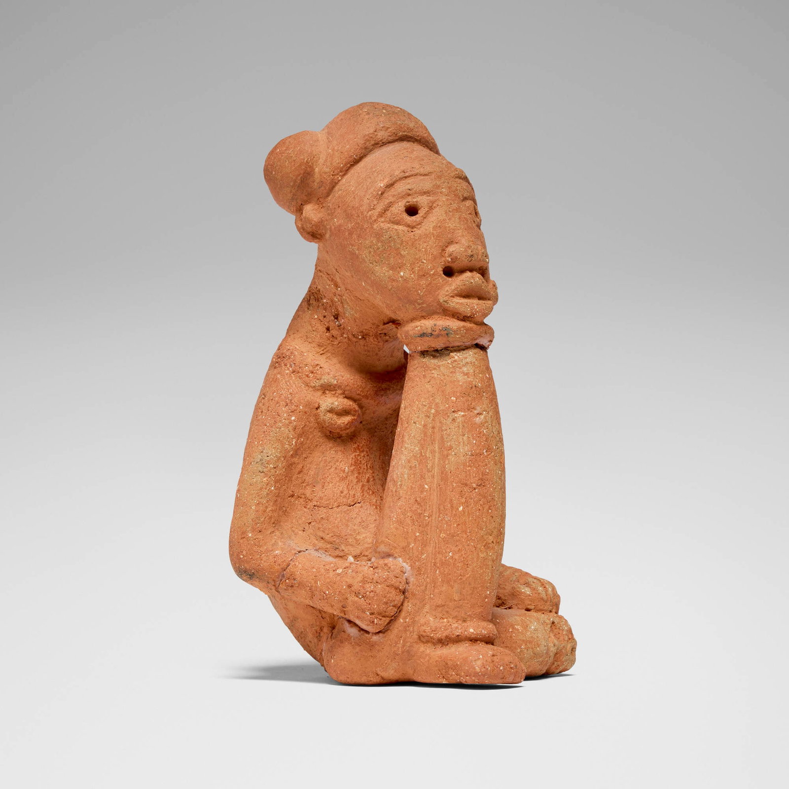 Nok, Seated figure: Nok Seated figure Nigeria, c. 500 BCE-500 CE terracotta 8.42 h x 4.25 w x 4.25 d in (21 x 11 x 11 cm) Provenance: Private Collection, California This work will ship from Los Angeles, California.