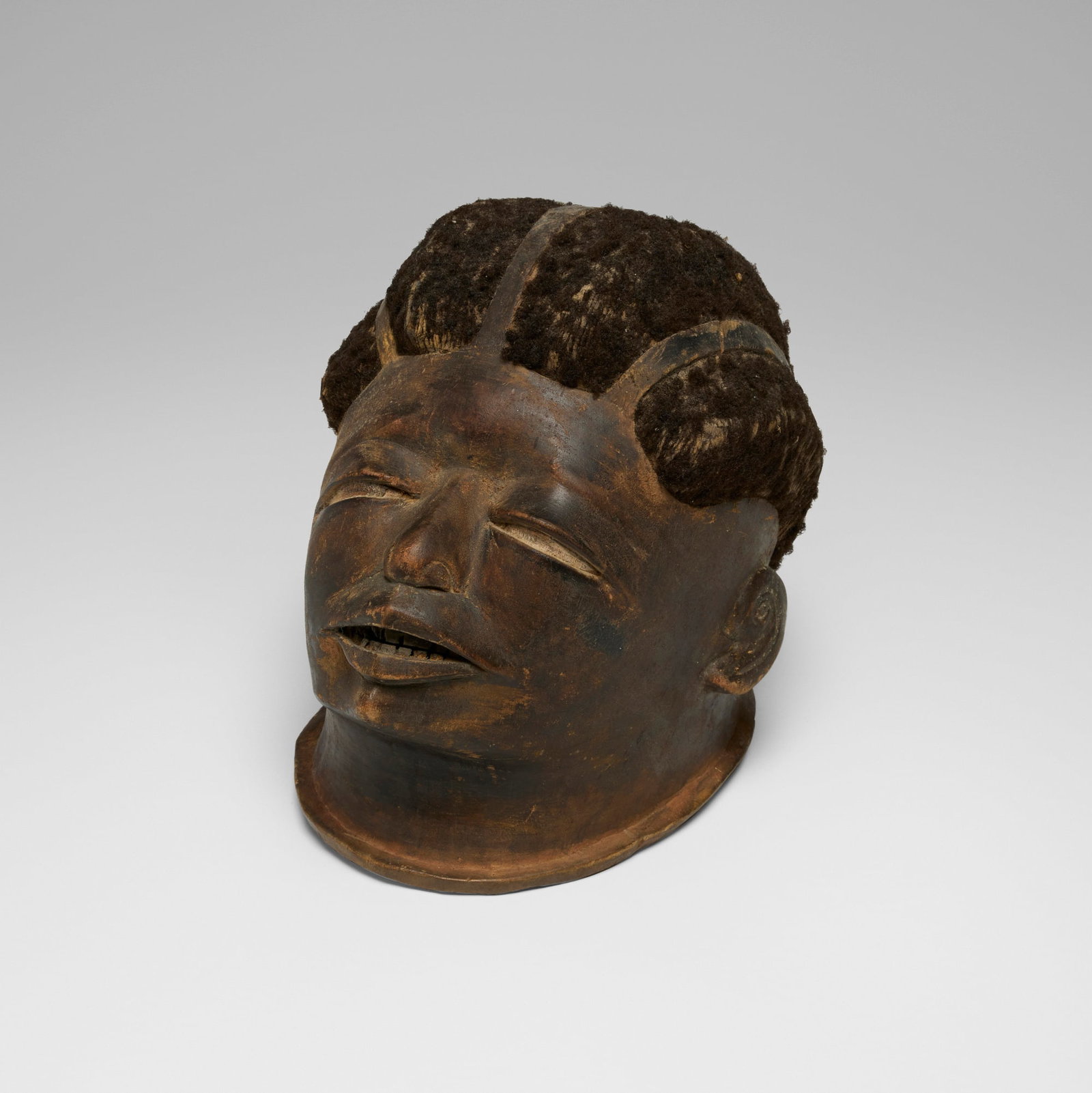 Makonde, Helmet mask: Makonde Helmet mask Tanzania, 20th century carved wood, hair 9.5 h x 8 w x 10 d in (24 x 20 x 25 cm) Provenance: Private Collection, Maryland This work will ship from Chicago, Illinois.