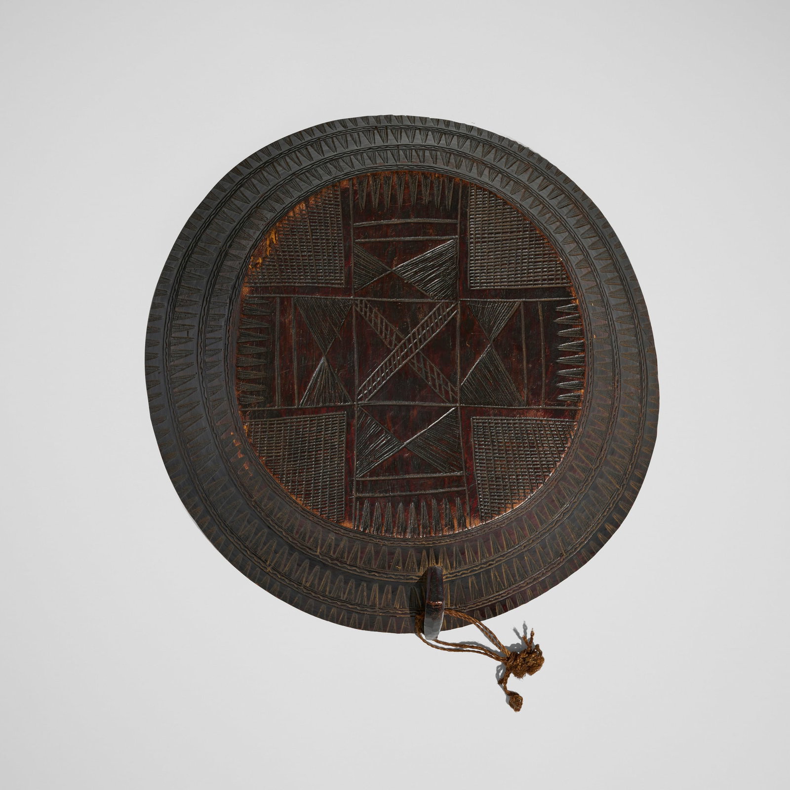 Gurage, Taba (serving dish): Gurage Taba (serving dish) Ethiopia, 20th century carved wood 4.5 h x 16.5 dia in (11 x 42 cm) The underside of this serving dish is carved with an ornate Coptic cross, allowing the vessel to serve