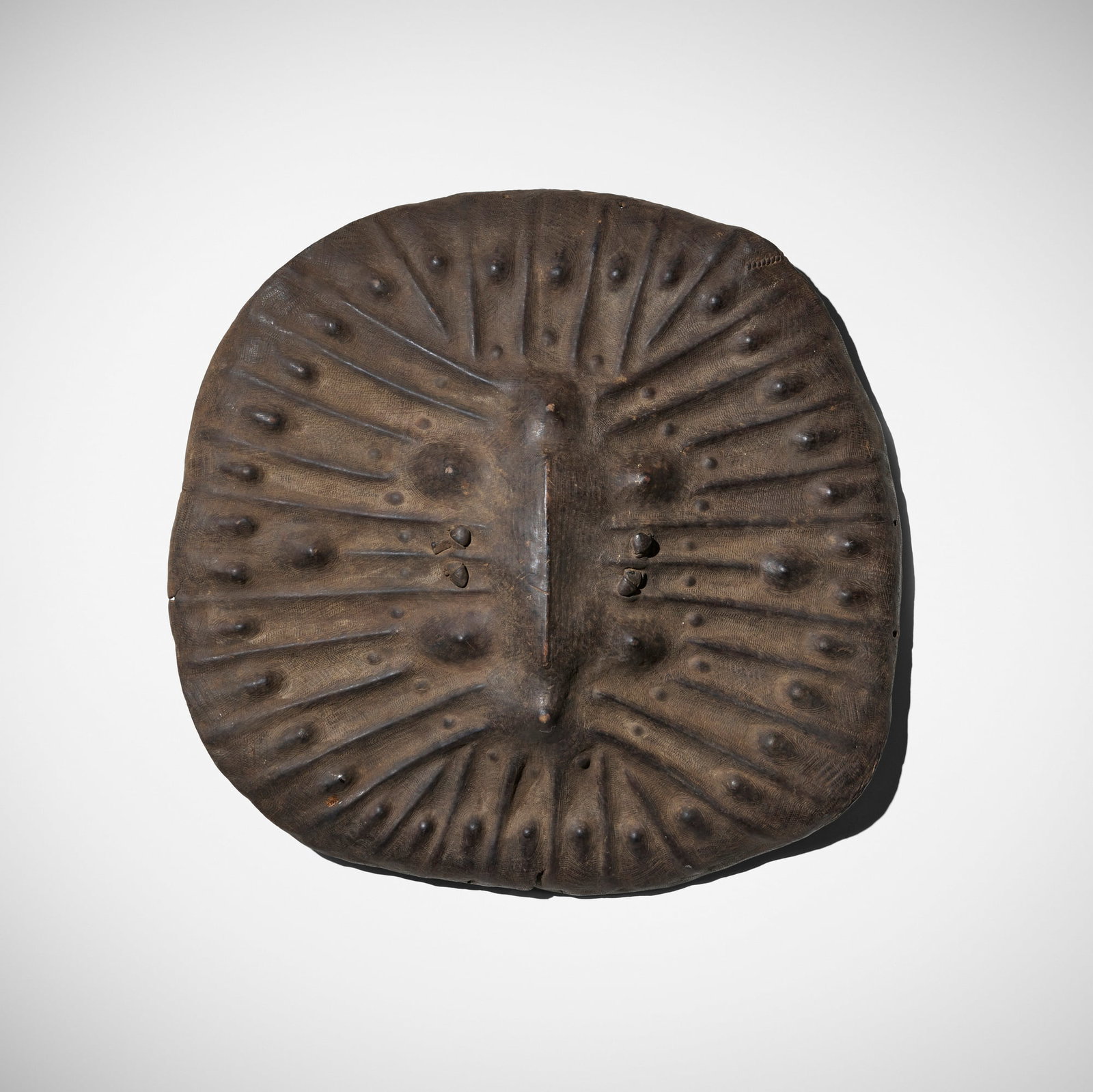 Oromo / Arussi (Arsi) / Amarro, Chawa shield: Oromo / Arussi (Arsi) / Amarro Chawa shield Southern Ethiopia, late 19th/early 20th century hardened hippopotamus hide 28 h x 29 dia in (71 x 74 cm) These rare embossed and incised shields of