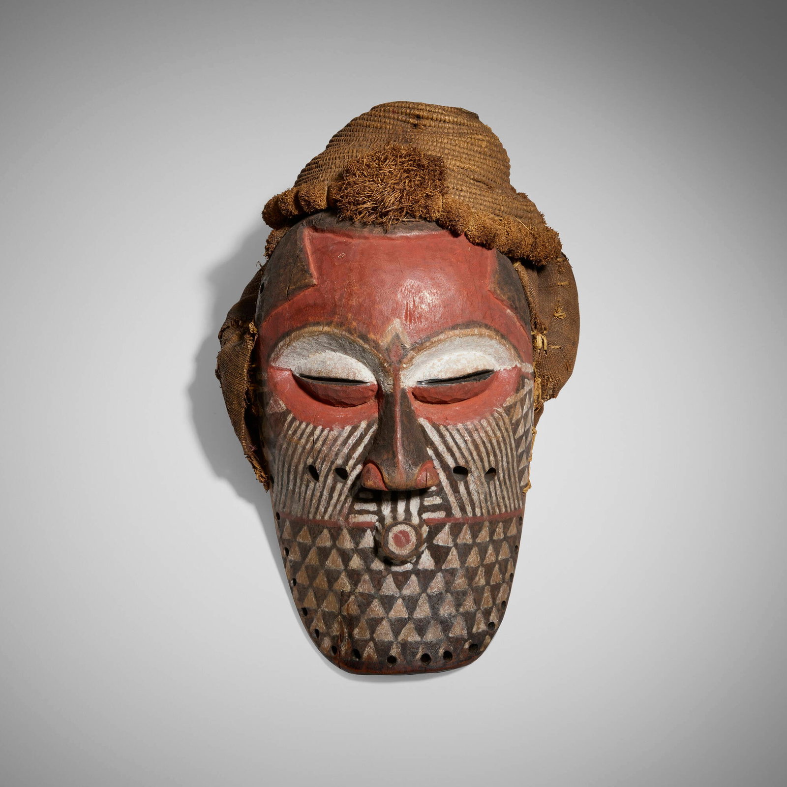 Biombo, Mask: Biombo Mask Democratic Republic of the Congo, early 20th century carved and painted wood, fiber cloth, raffia 15 h x 9.5 w x 9 d in (38 x 24 x 23 cm) Provenance: Pace Primitive, New York | Acquired