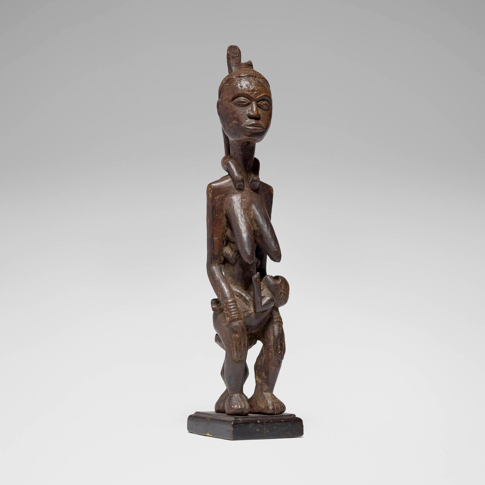 Yoruba, Maternity figure: Yoruba Maternity figure Nigeria, 20th century carved wood 27.5 h x 7 w x 5.5 d in (70 x 18 x 14 cm) This work will ship from Los Angeles, California.